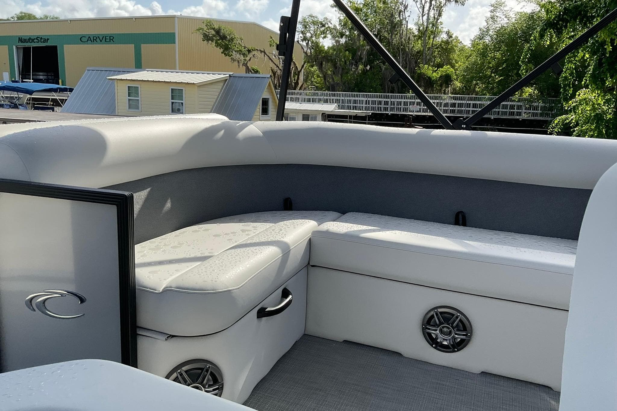 Interior of 2026 Crest Conquest SE 220 Cruise boat with white seating and speaker.