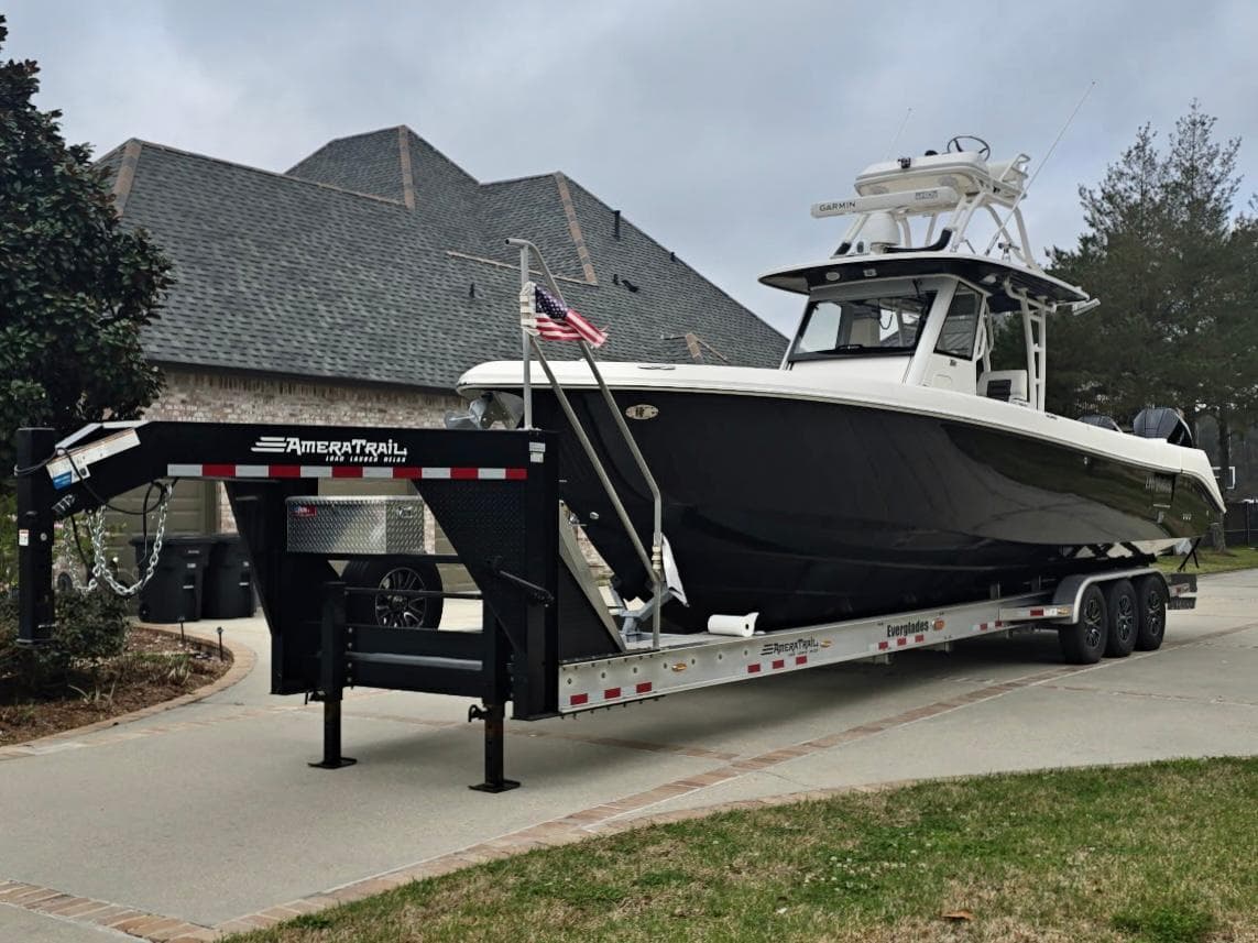 2015 Everglades 355 Tournament boat on trailer in residential driveway.