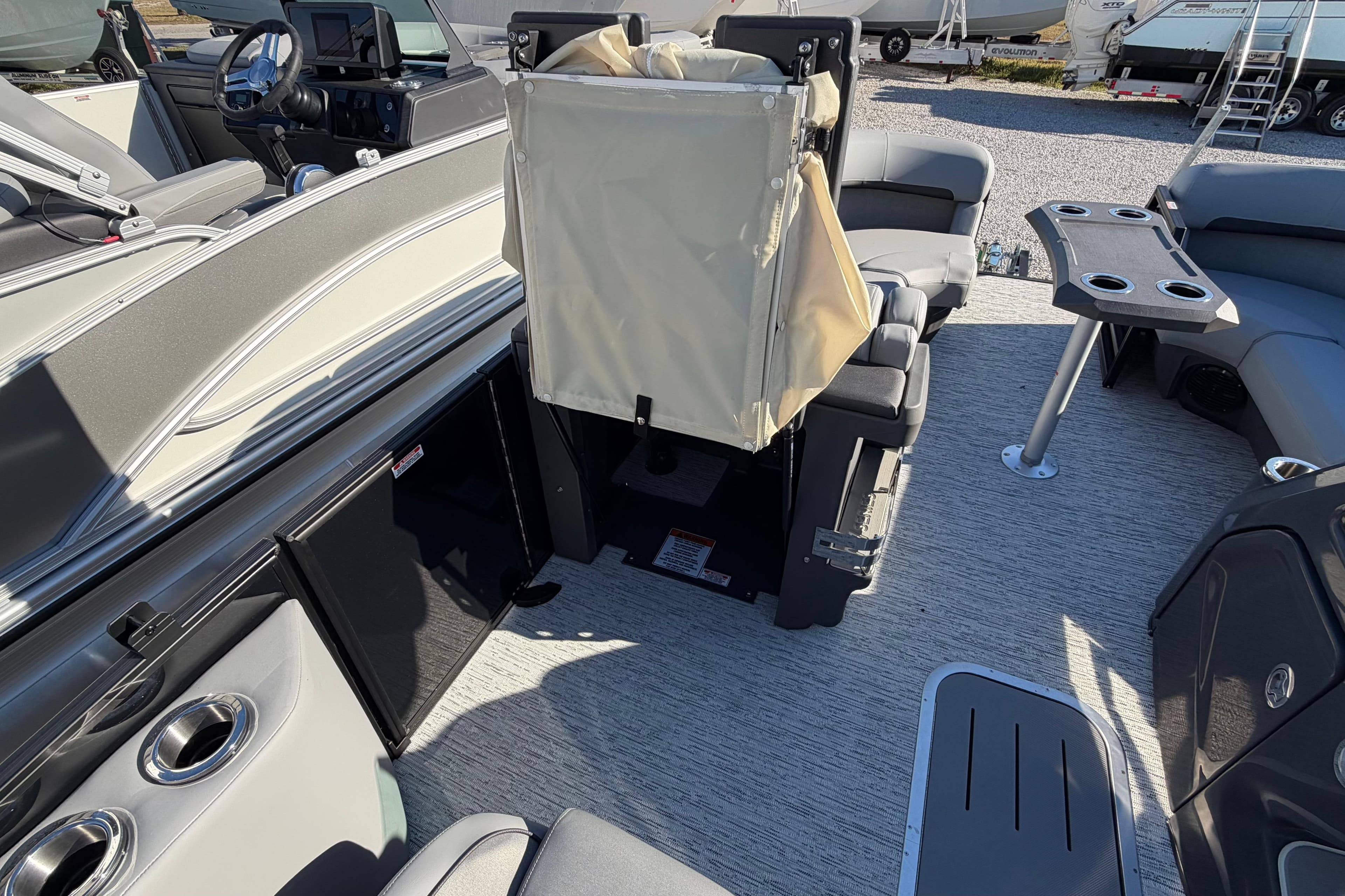 2026 Bennington 22 MFB boat interior with seating, table, and steering console.