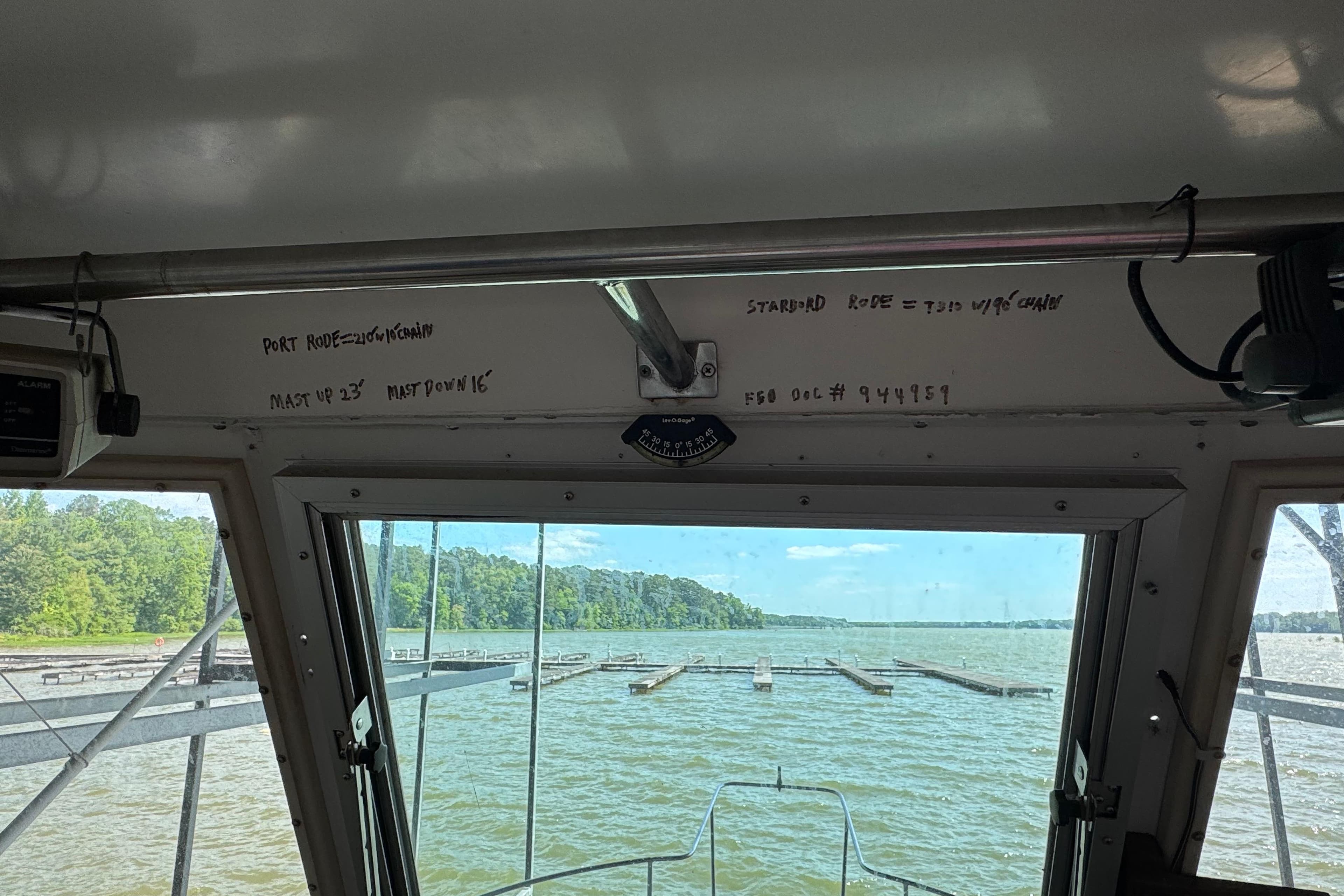Interior view from a 1984 Kadey-Krogen 36 Manatee boat, overlooking a serene lake.