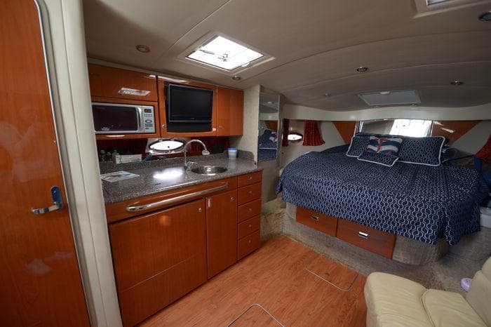 Interior of 2007 Formula 34 PC yacht with kitchen and cozy sleeping area.