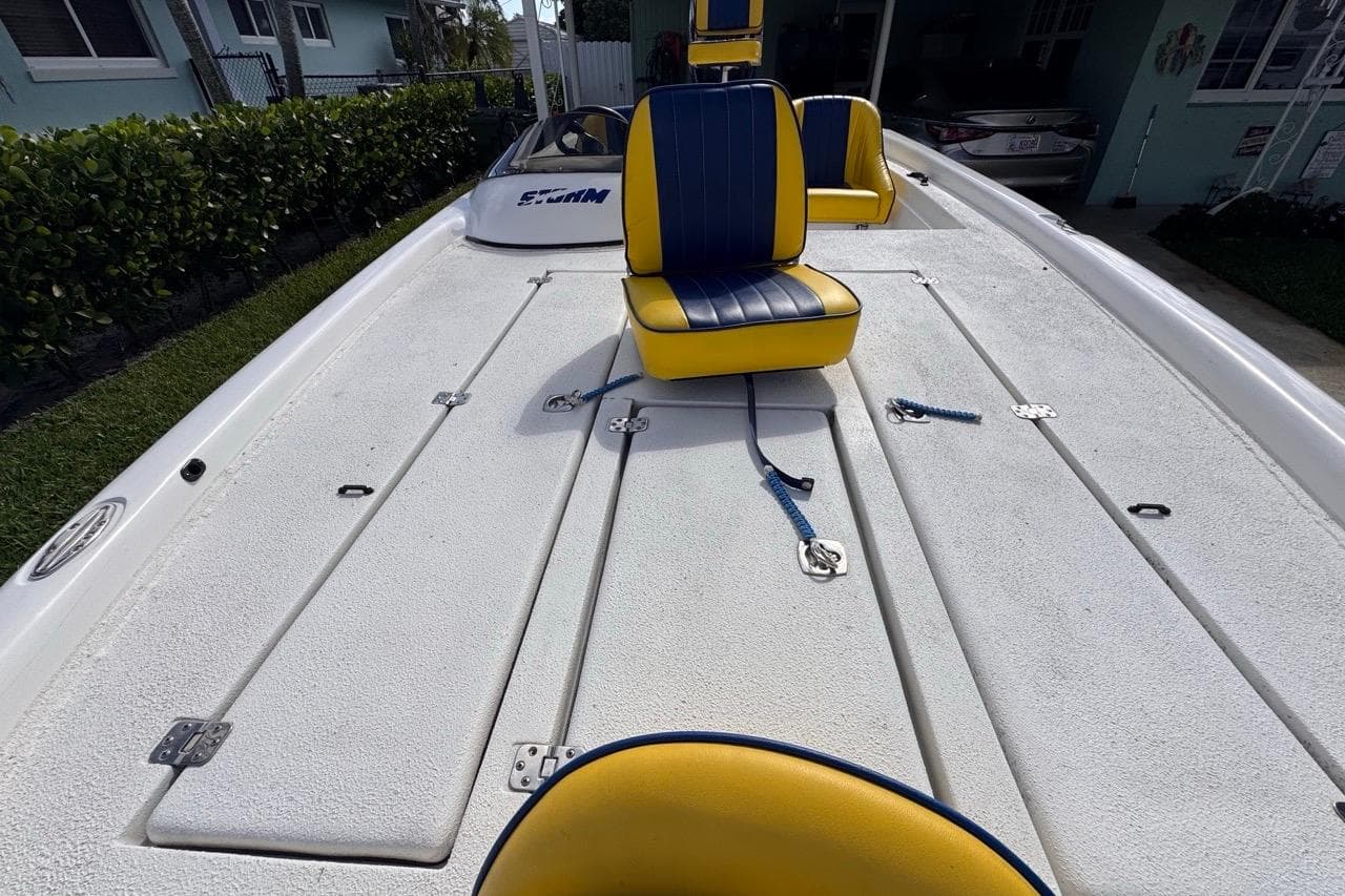 2005 Storm Boats Storm-High Performance with yellow and blue seating on deck.