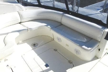 2005 Cruisers Yachts 370 Express interior with white seating and storage compartments.