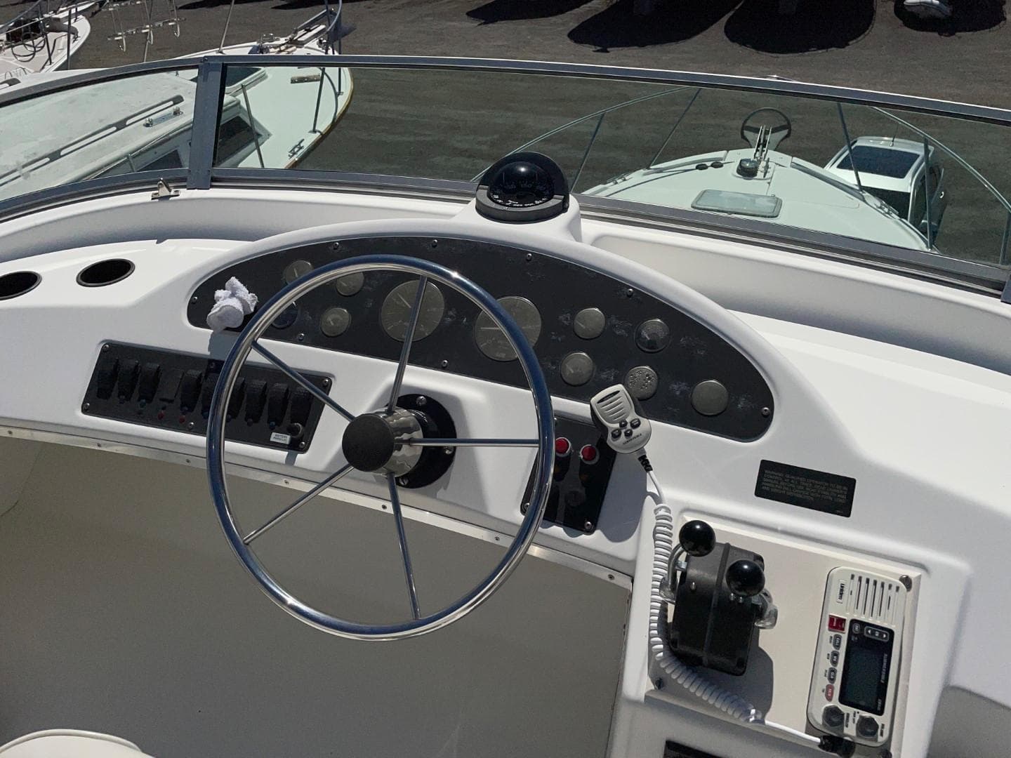 1999 Bayliner 3388 Motoryacht helm with steering wheel and navigation controls.