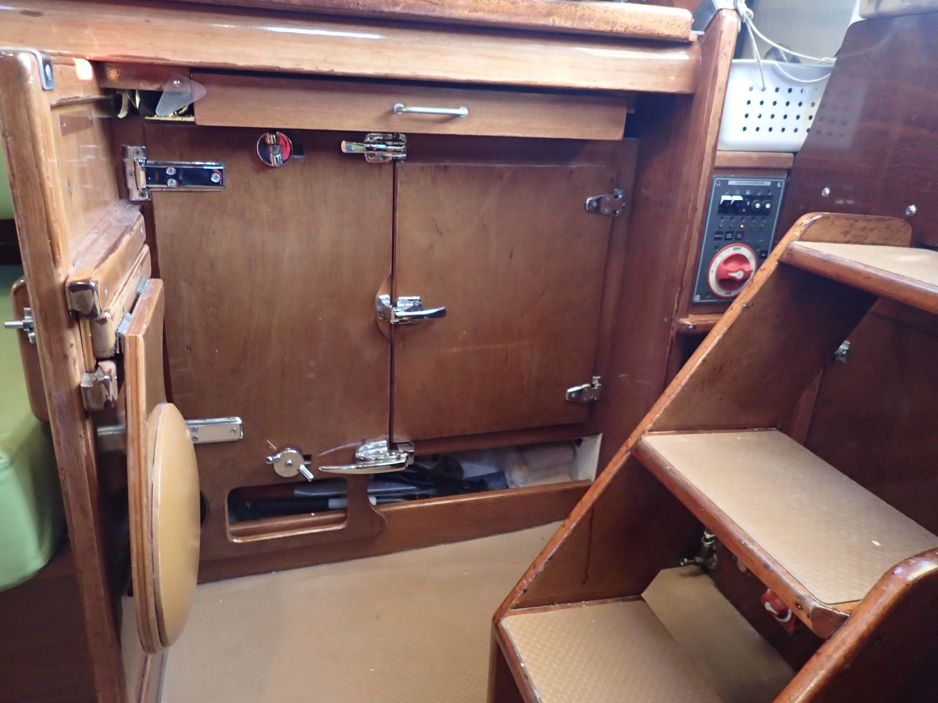 Interior of a 1975 Amel Euros 41 yacht with wooden cabinetry.