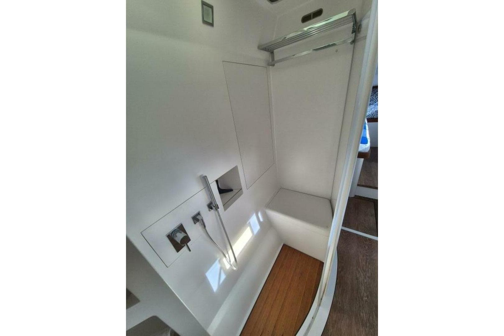 Modern shower area in 2016 Alibi 54 yacht with sleek design and wooden flooring.