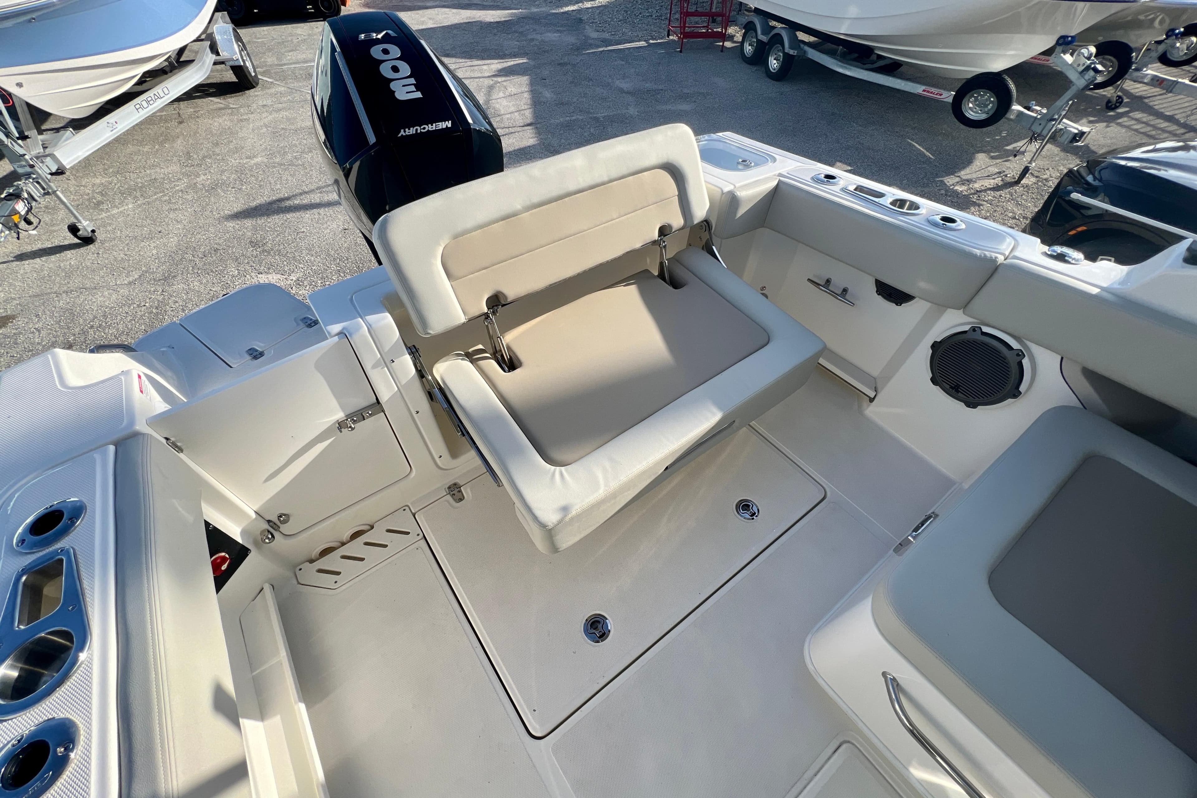 Interior of 2025 Boston Whaler 240 Vantage with seating and motor.
