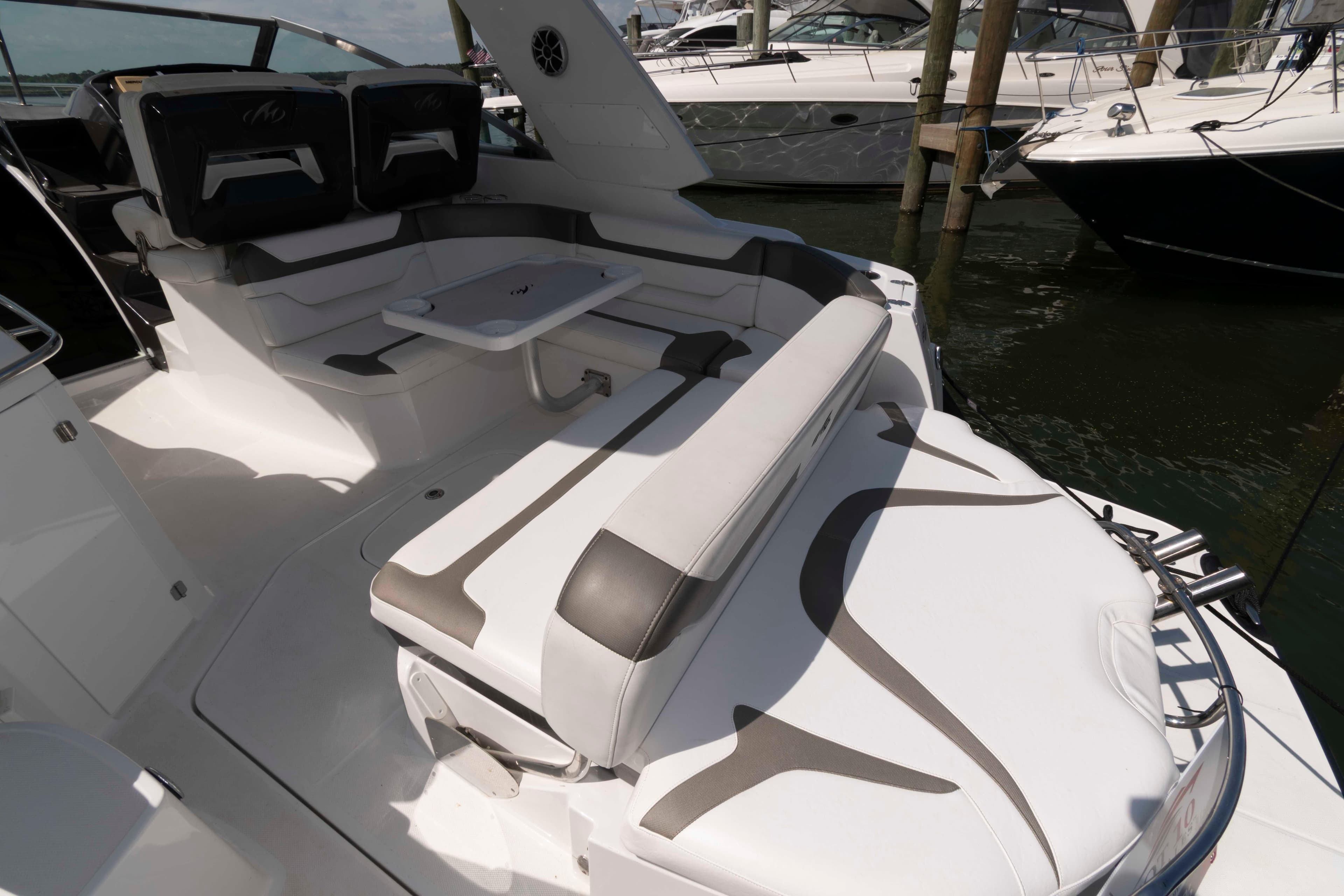 2015 Monterey 355 Sport Yacht interior with seating and table, docked at marina.