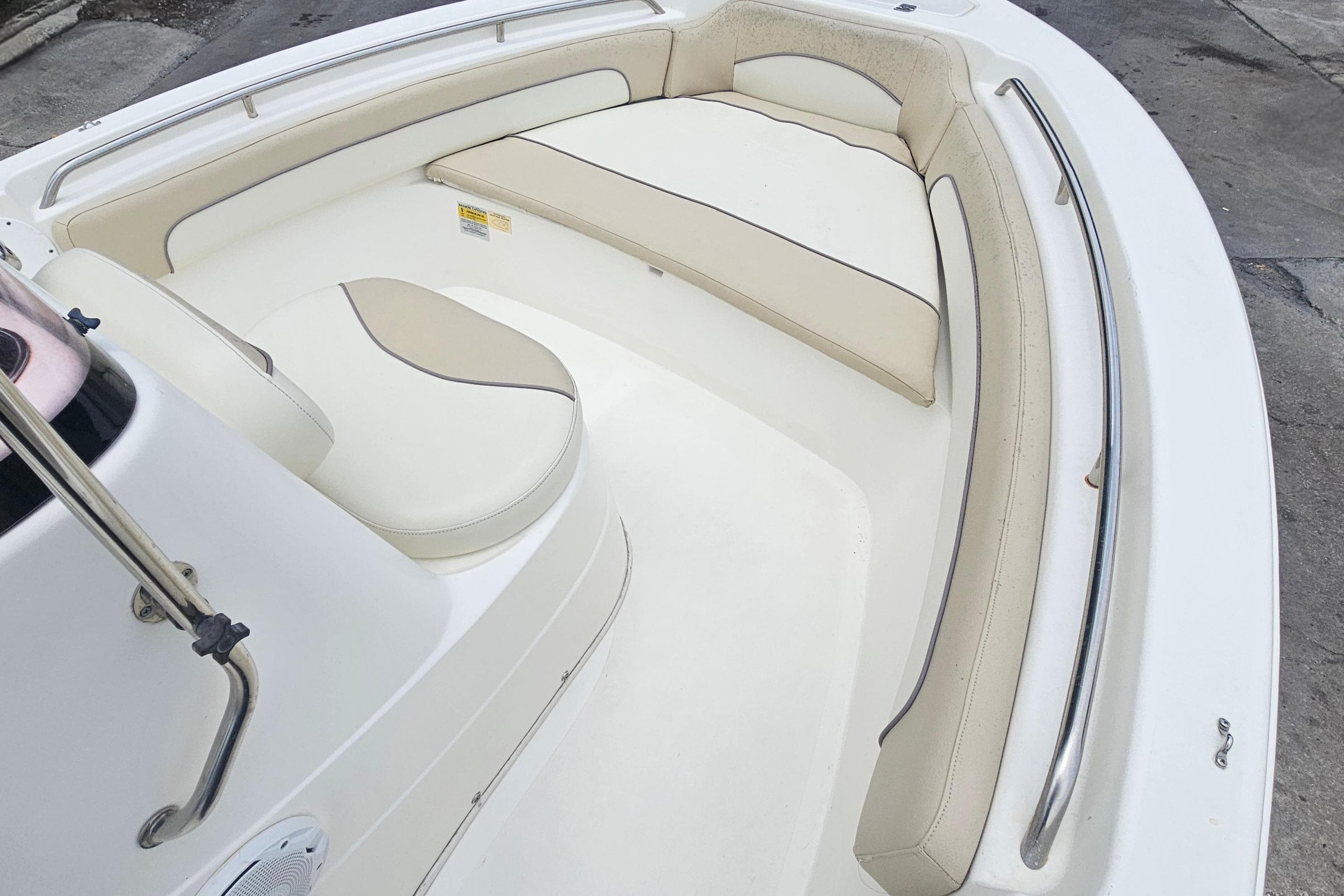 2018 NauticStar 19 XS boat interior with cushioned seating and stainless steel railings.