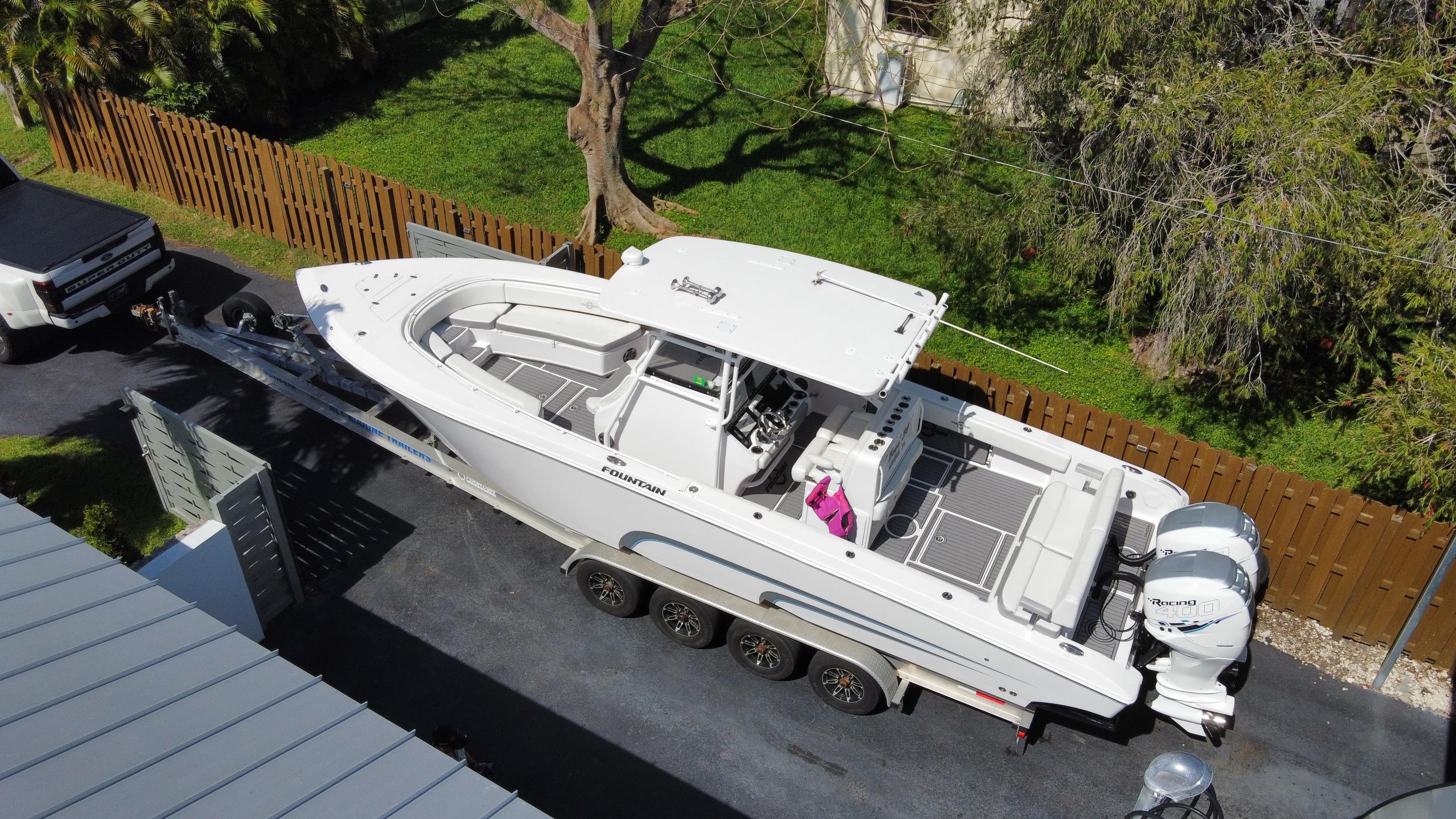 2018 Fountain 34 CC boat on a trailer in a driveway.
