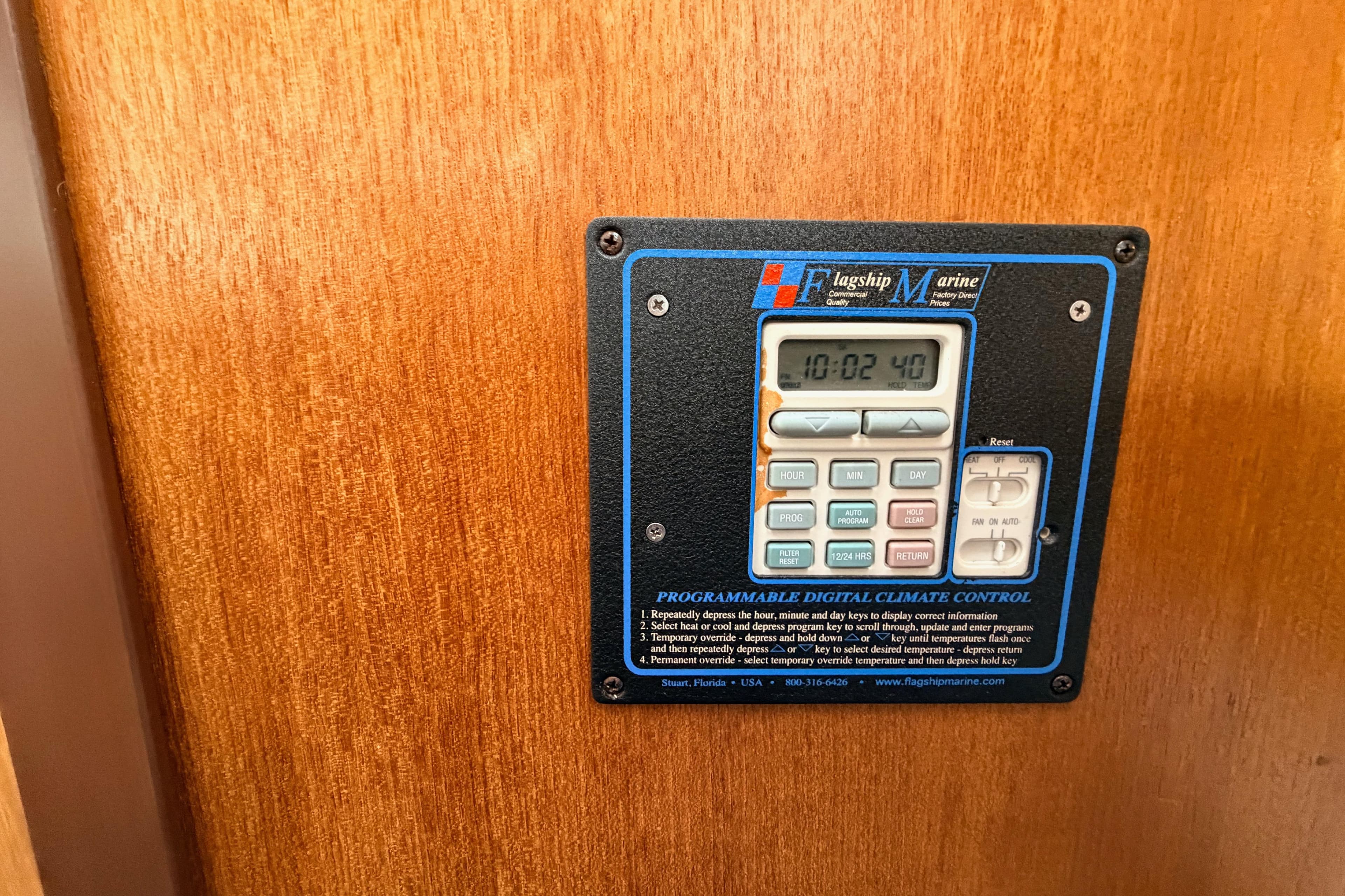 Programmable digital climate control on 2001 Catalina 380 boat, mounted on wooden panel.