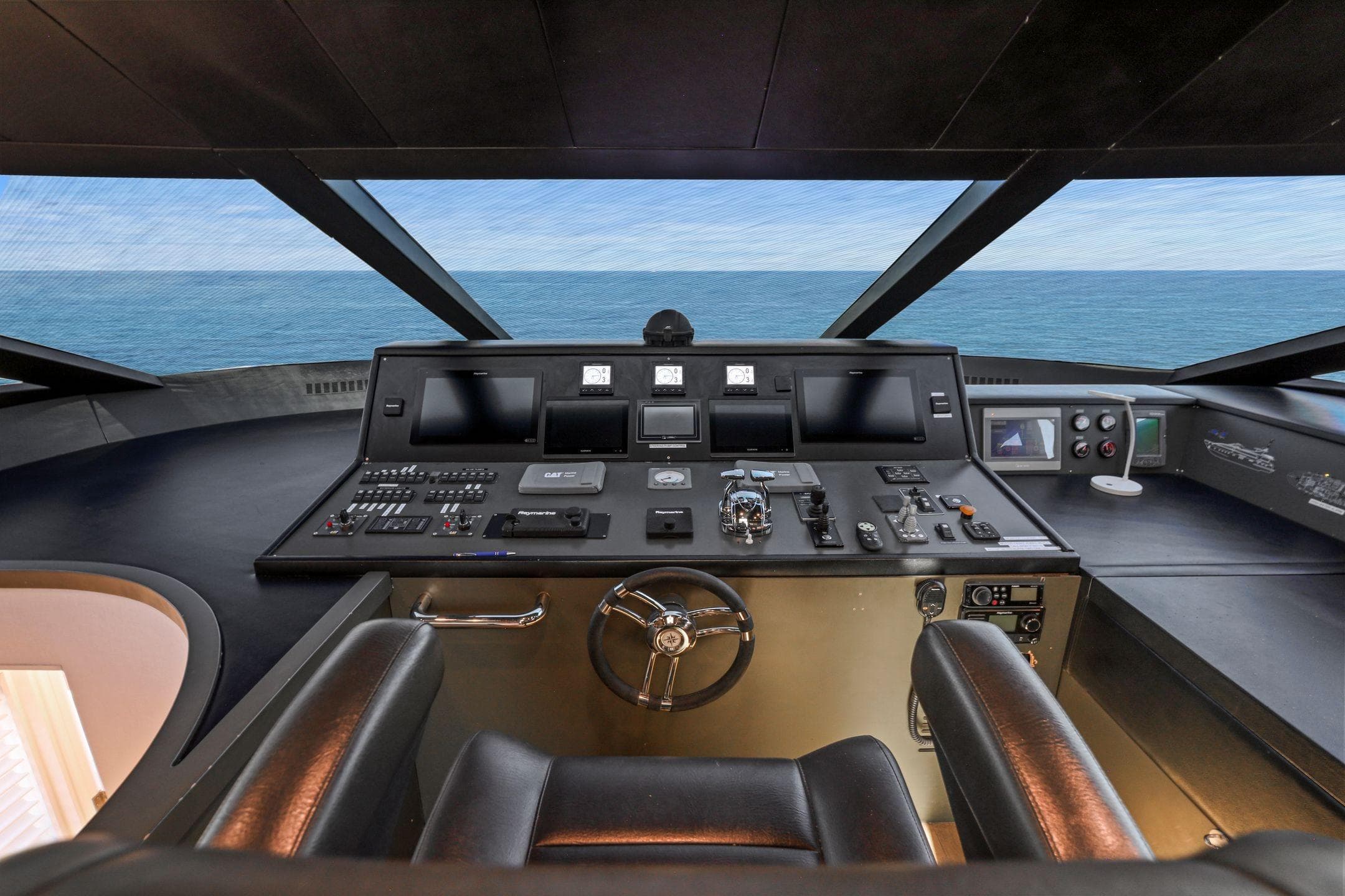Luxurious helm of 2011 Mengi Yay 115 MY yacht with ocean view.