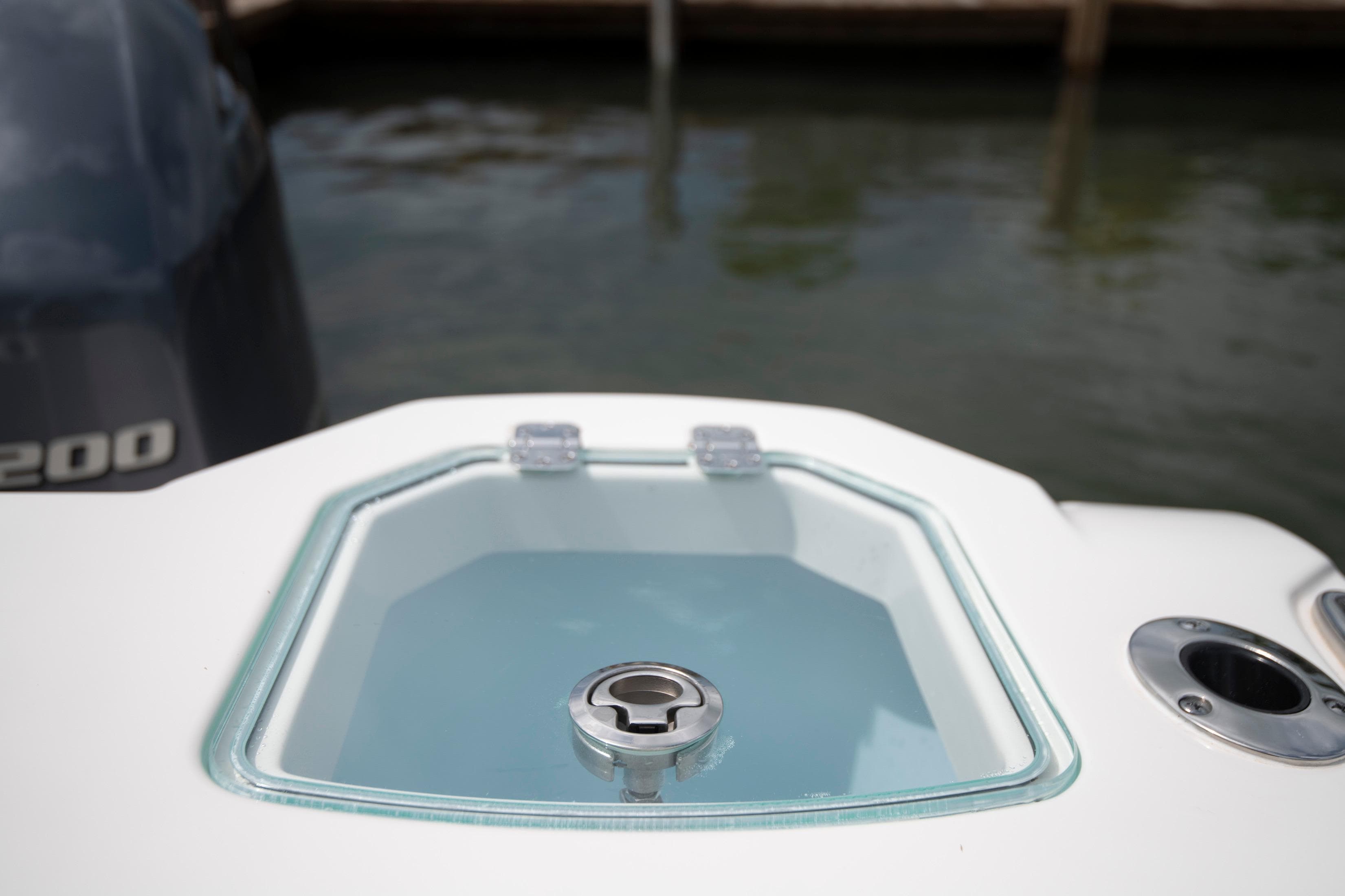 Livewell on 2027 Sailfish 272 CC boat, docked near water.