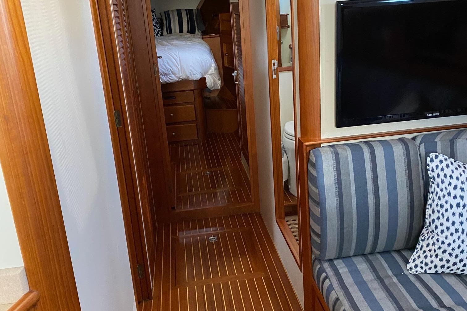 Interior of 2001 Grand Banks 49 Eastbay SX with wood flooring and striped seating.