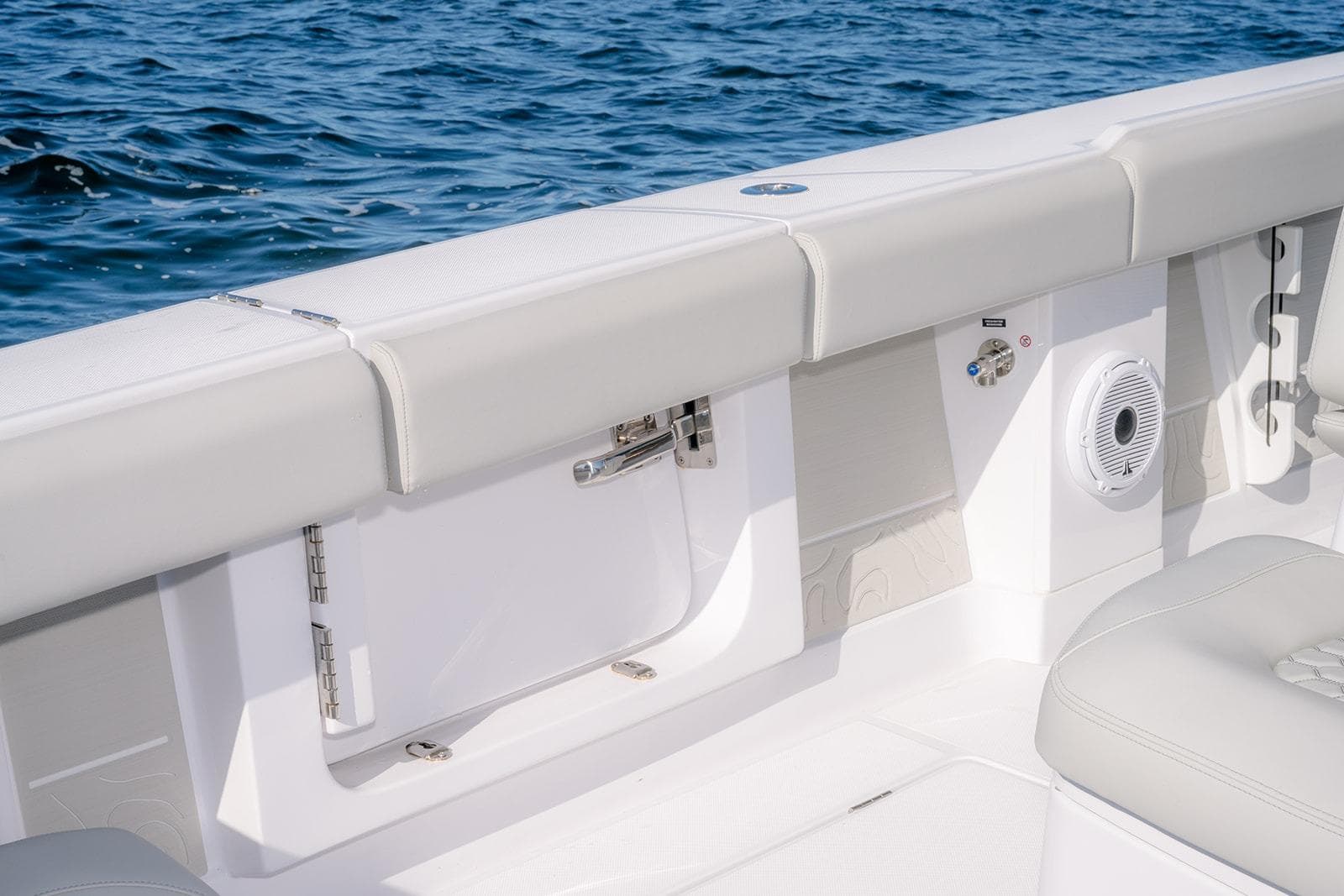 2026 Jupiter 340LS boat interior with white seating and ocean backdrop.