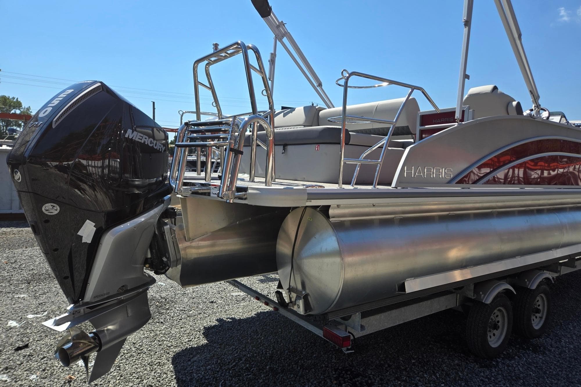 2026 Harris Cruiser 230 pontoon boat with Mercury outboard engine on trailer.