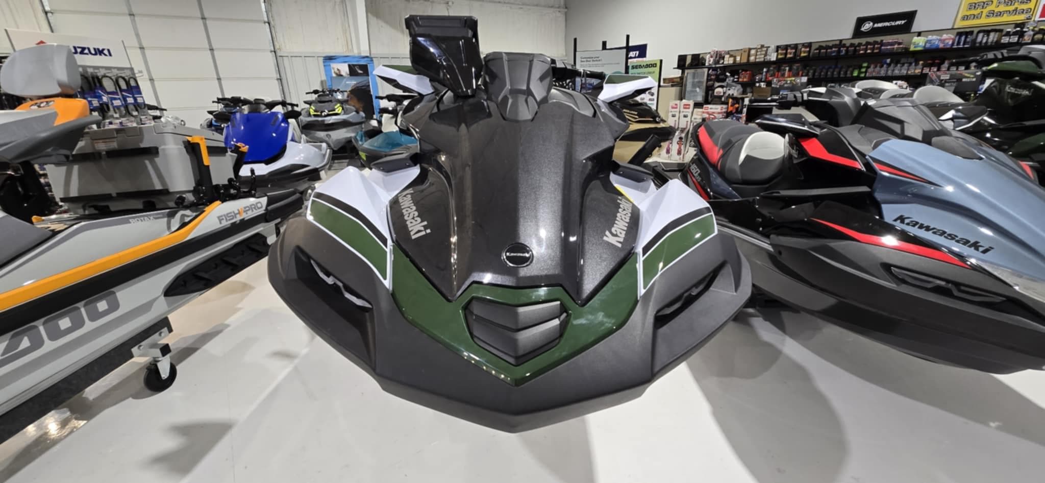 2025 Kawasaki Jetski Ultra 160 LX-S Angler displayed in a showroom with other models.