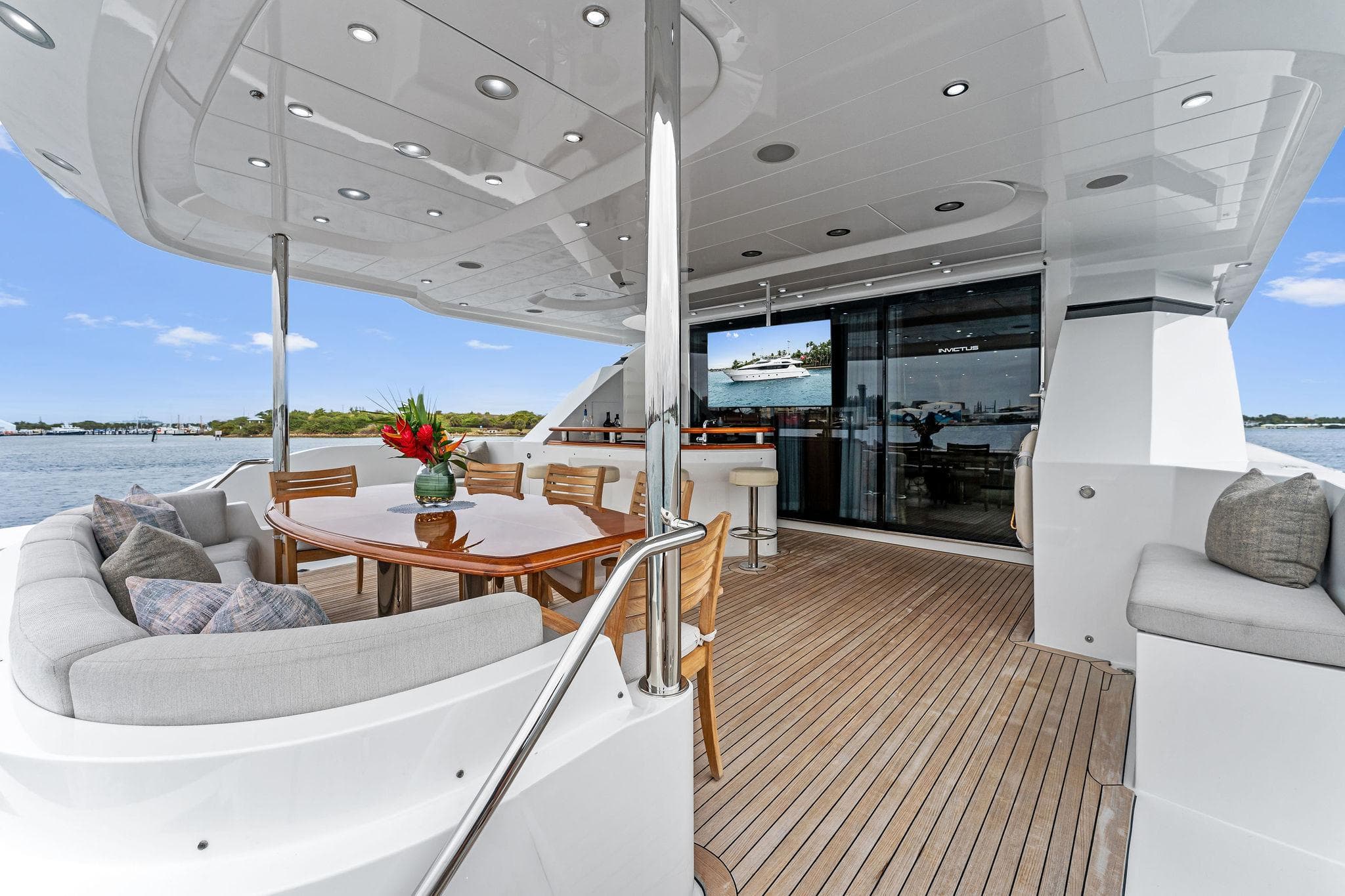 Luxurious 2006 Palmer Johnson motor yacht deck with elegant seating and dining area.