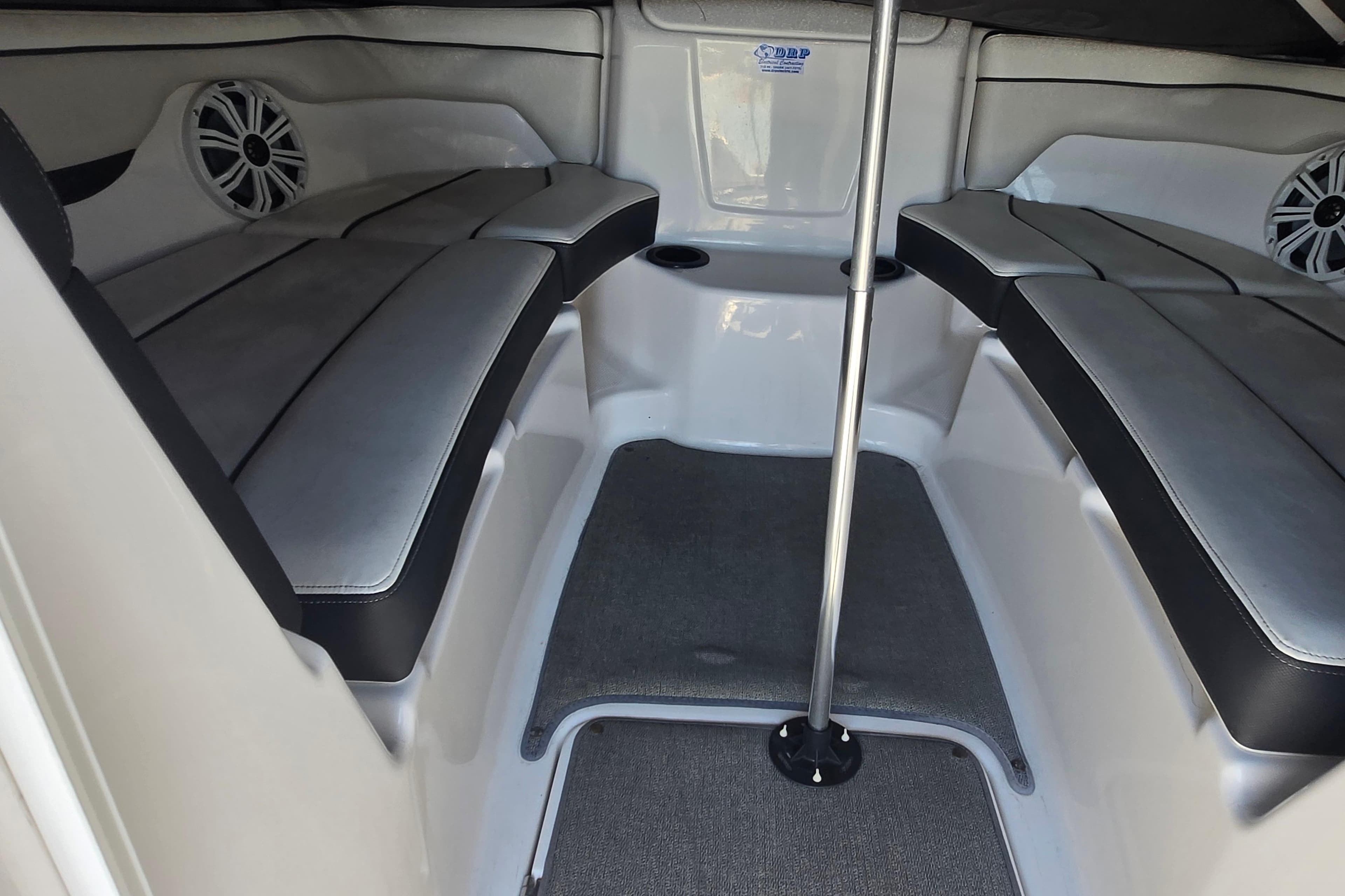 2018 Yamaha Boats AR210 interior with cushioned seating and speaker system.