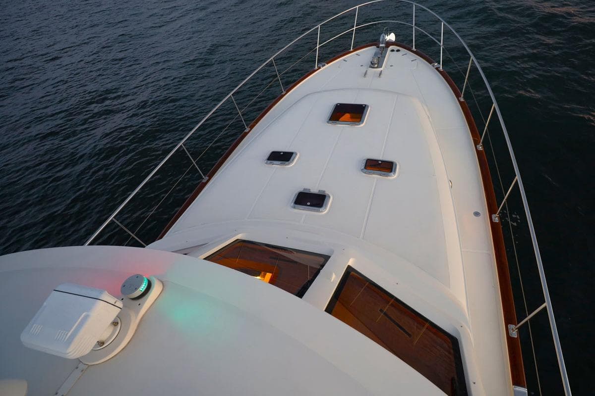 Bow view of 2014 Hunt Yachts 44 on calm water, showcasing deck and railings.