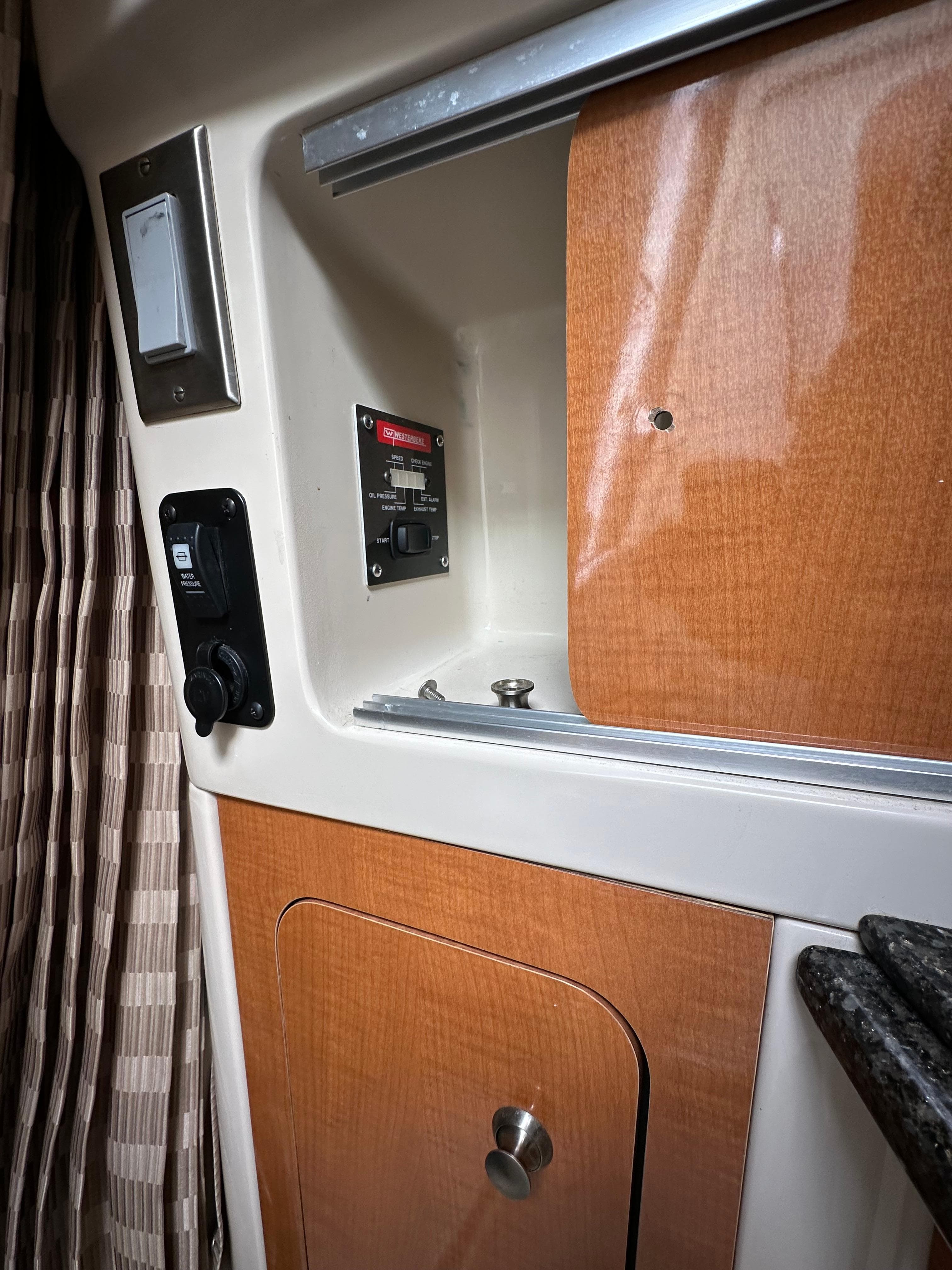 2007 Chaparral Signature 270 interior cabin with wood paneling and control panel.