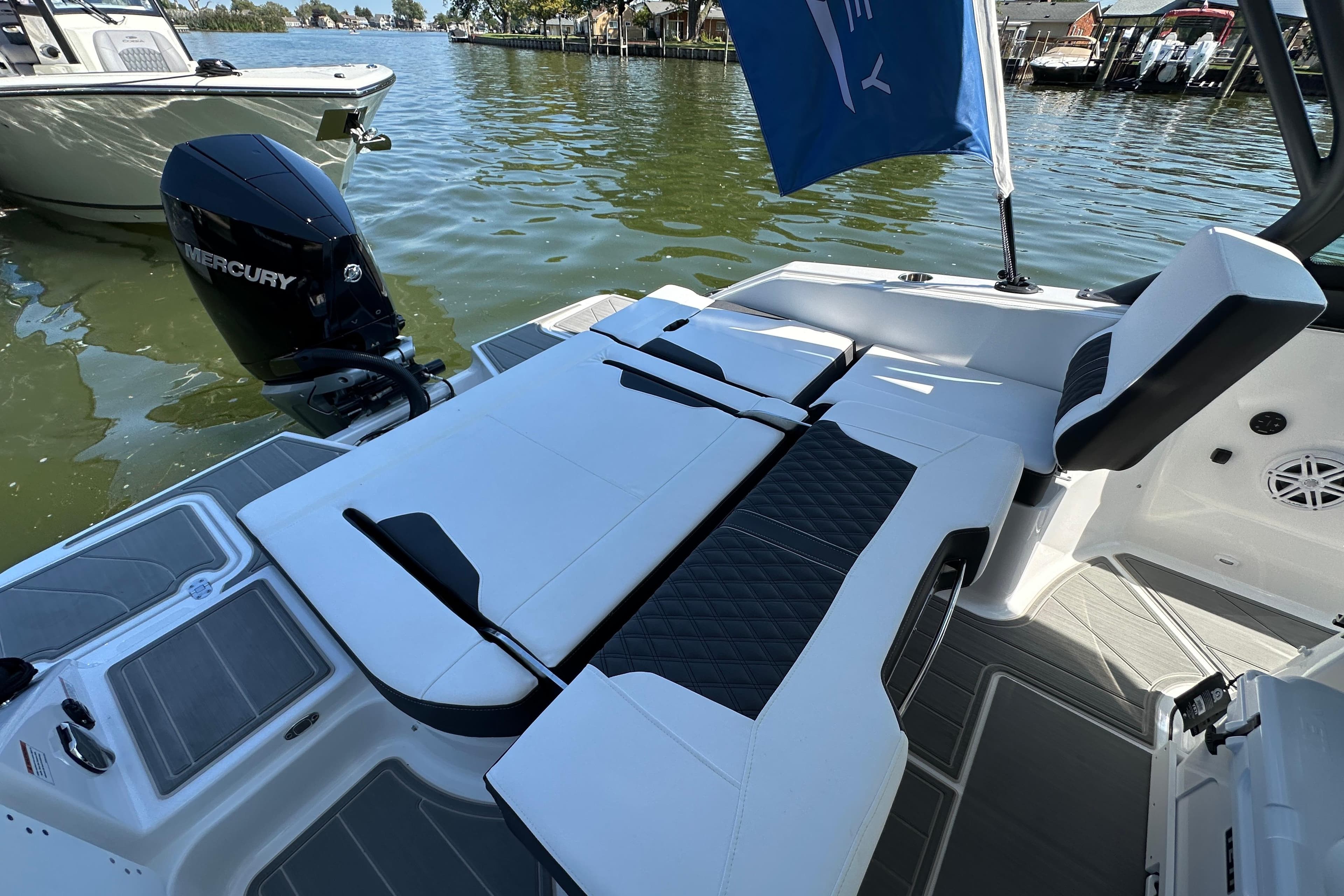 2026 Monterey Elite 25 OB boat with Mercury engine, featuring sleek seating and modern design.