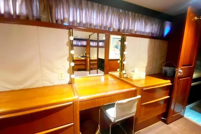 Vanity area in a 1990 Viking Motor Yacht with wooden cabinetry and mirror.