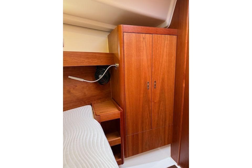 Interior cabin of 2017 Dehler 38 yacht with wooden wardrobe and bed.