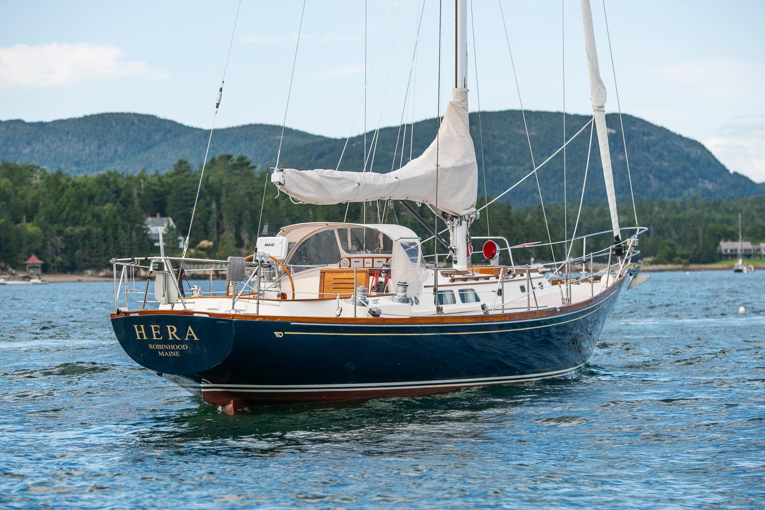 Hinckley Sou'wester 42 Sloop, 1994, sailing on calm waters with scenic mountain backdrop.