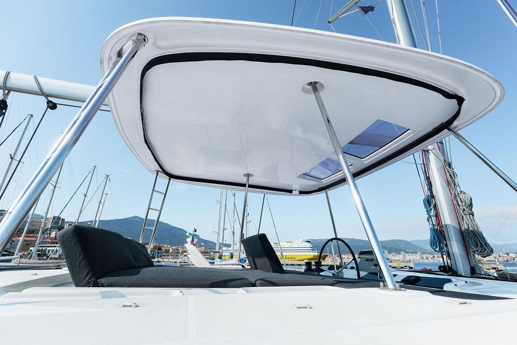 Lagoon 46 catamaran 2021 model with sleek design and spacious deck in marina setting.