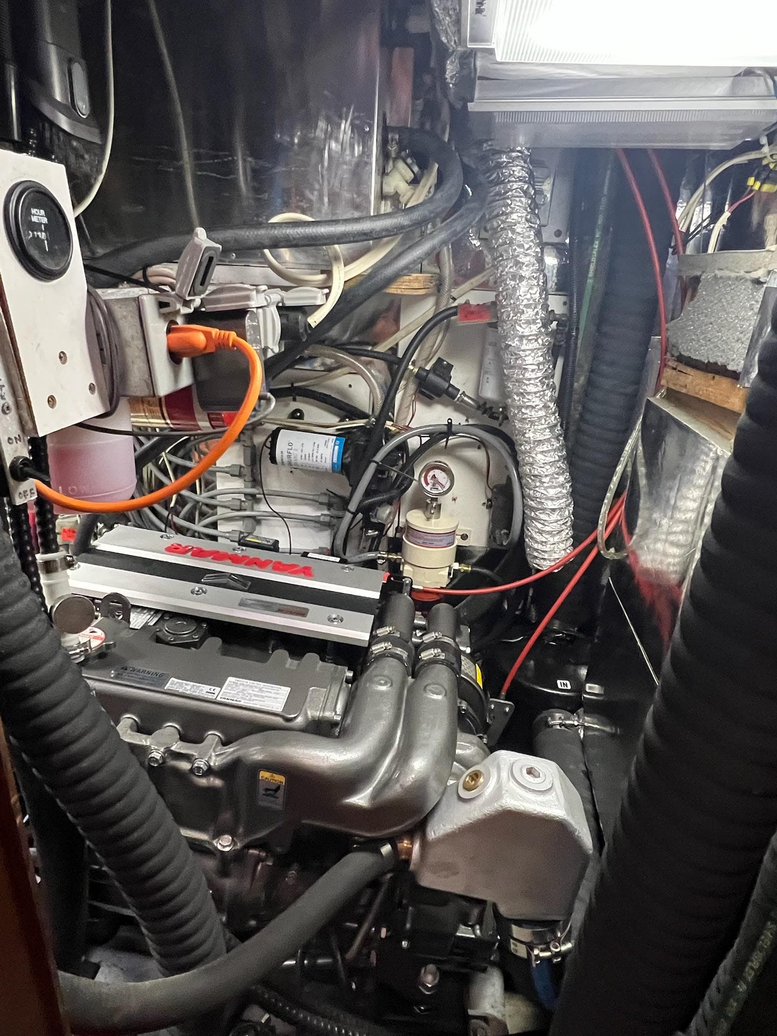 Engine room of a 1992 Endeavour 45 sailboat, showcasing mechanical components and wiring.