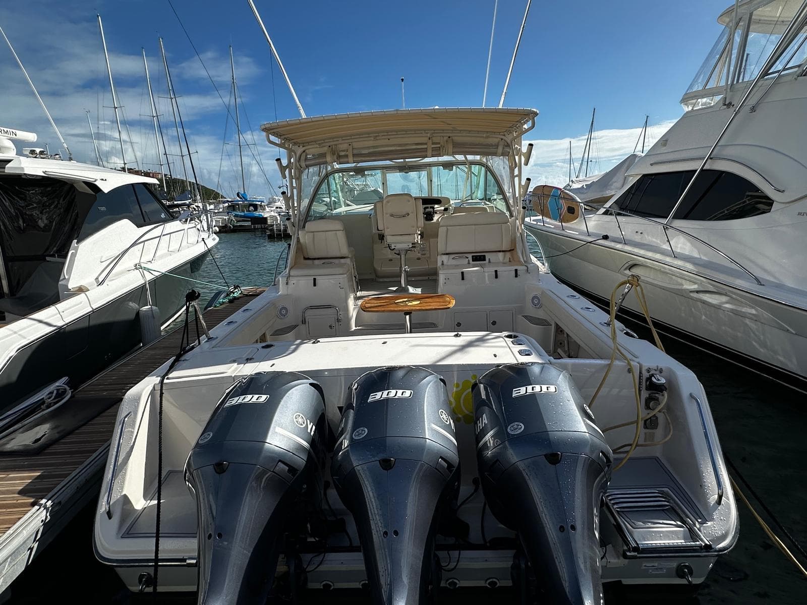 2016 Grady-White Express 370 boat docked with triple outboard engines.