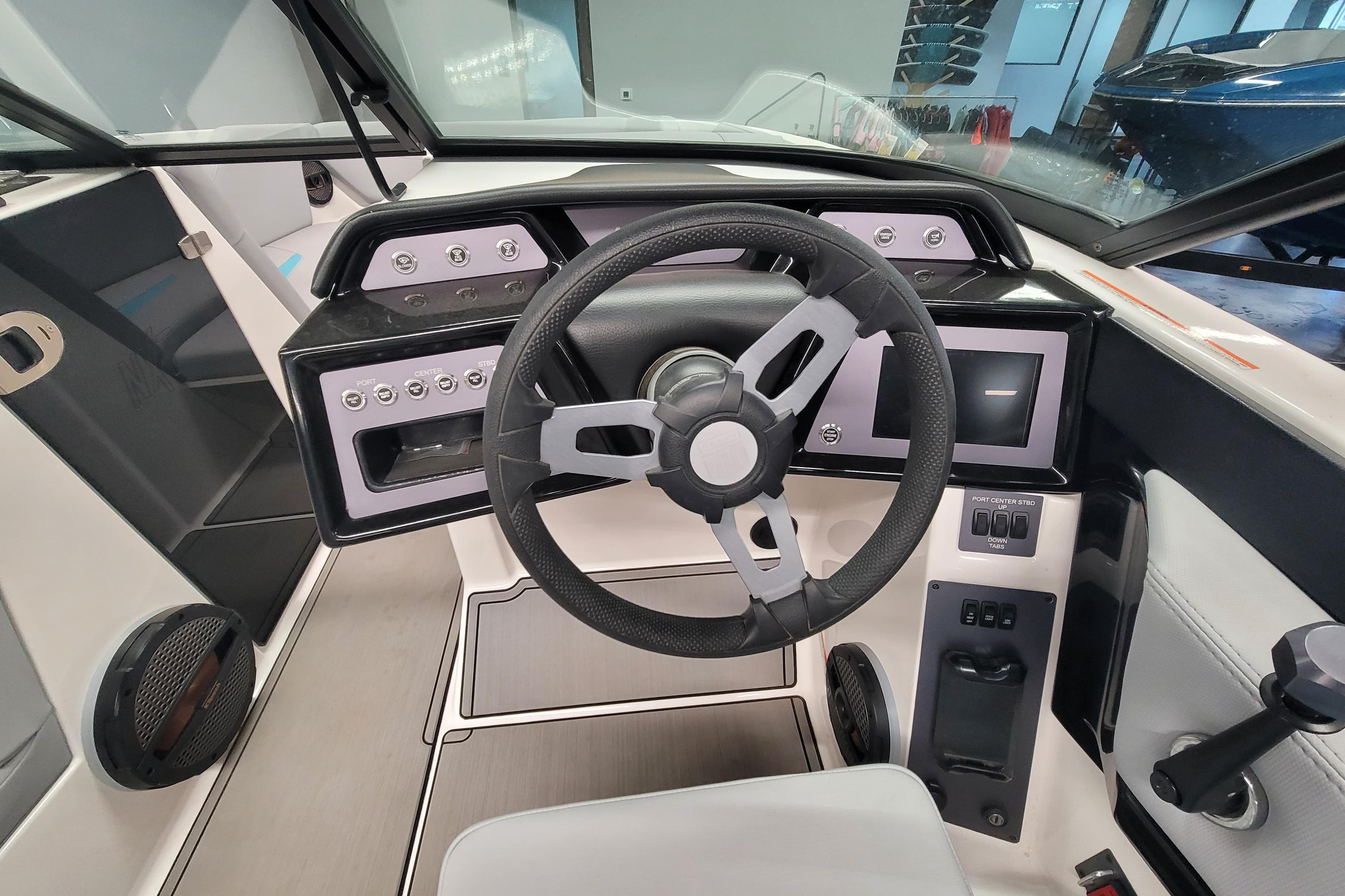 2024 MasterCraft NXT24 boat cockpit with modern steering wheel and control panel.