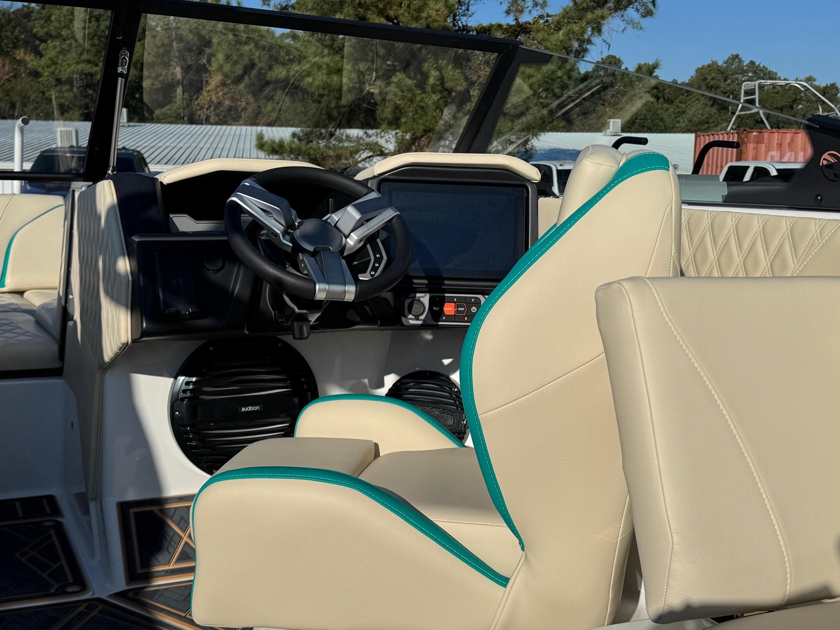 2025 Tigé 22RZX boat interior with beige seats and modern dashboard.