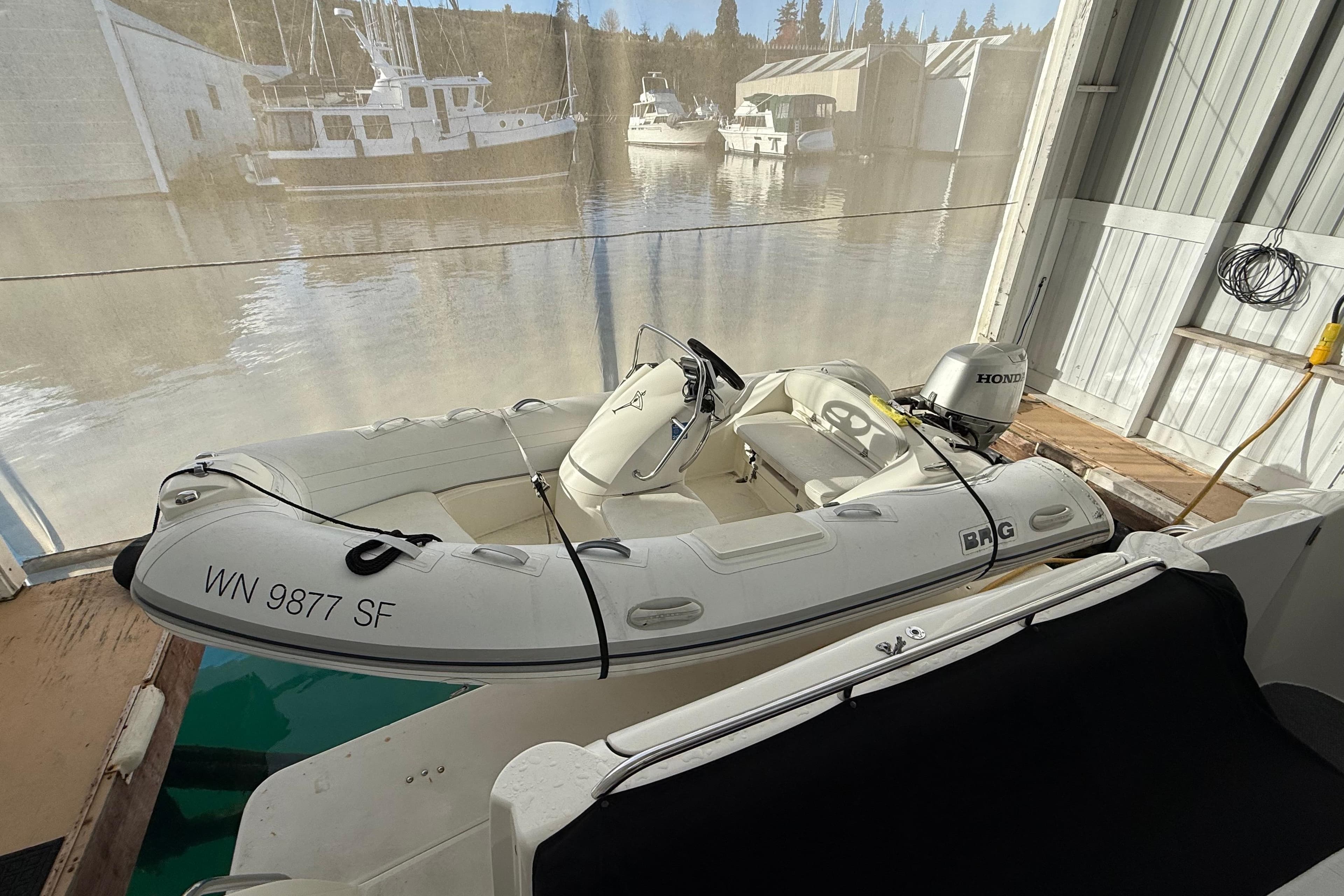 Inflatable boat docked beside 1997 Bayliner 5788 Pilot House Motoryacht.
