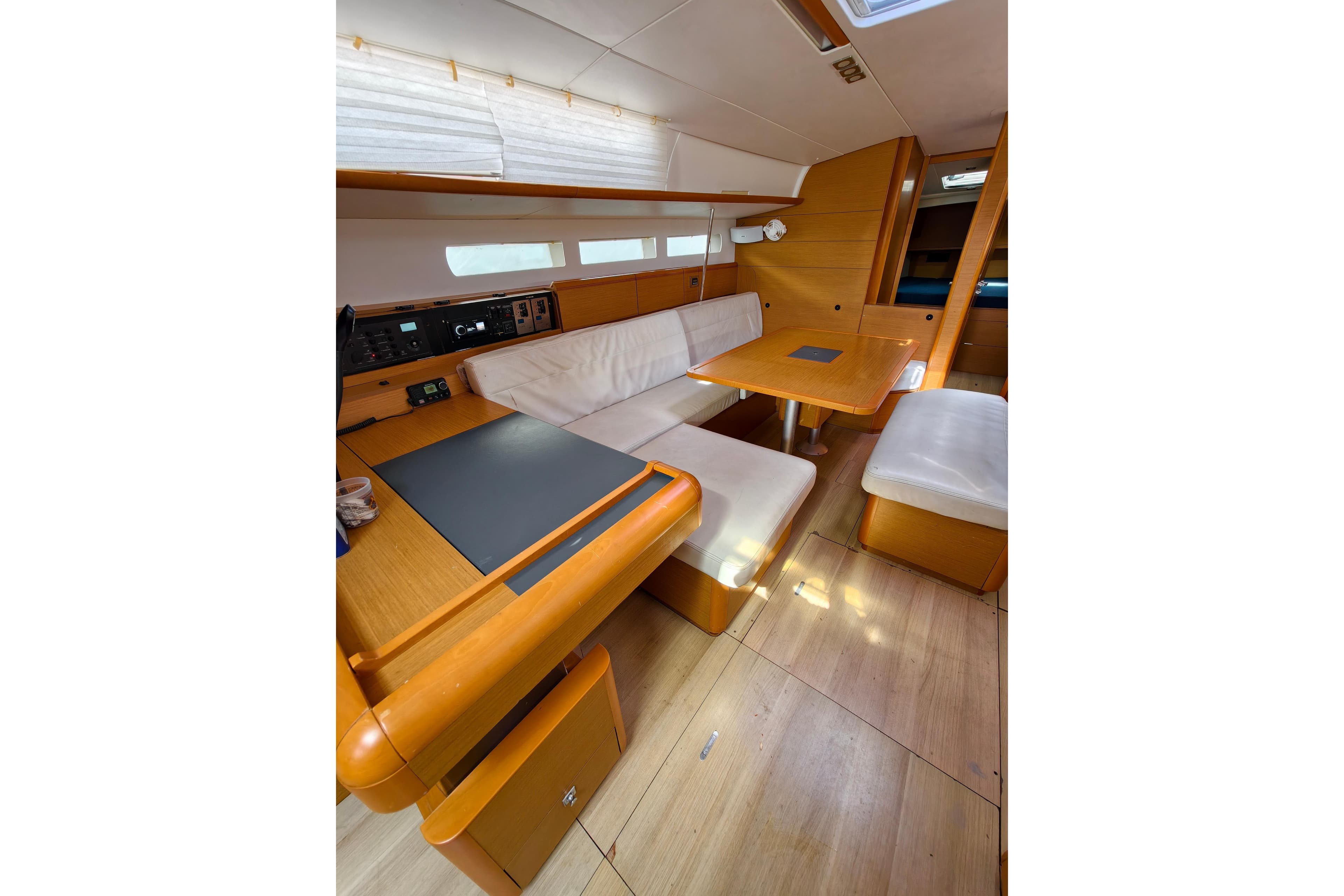 Interior of 2016 Jeanneau Sun Odyssey 509 sailboat with wooden furnishings and seating area.