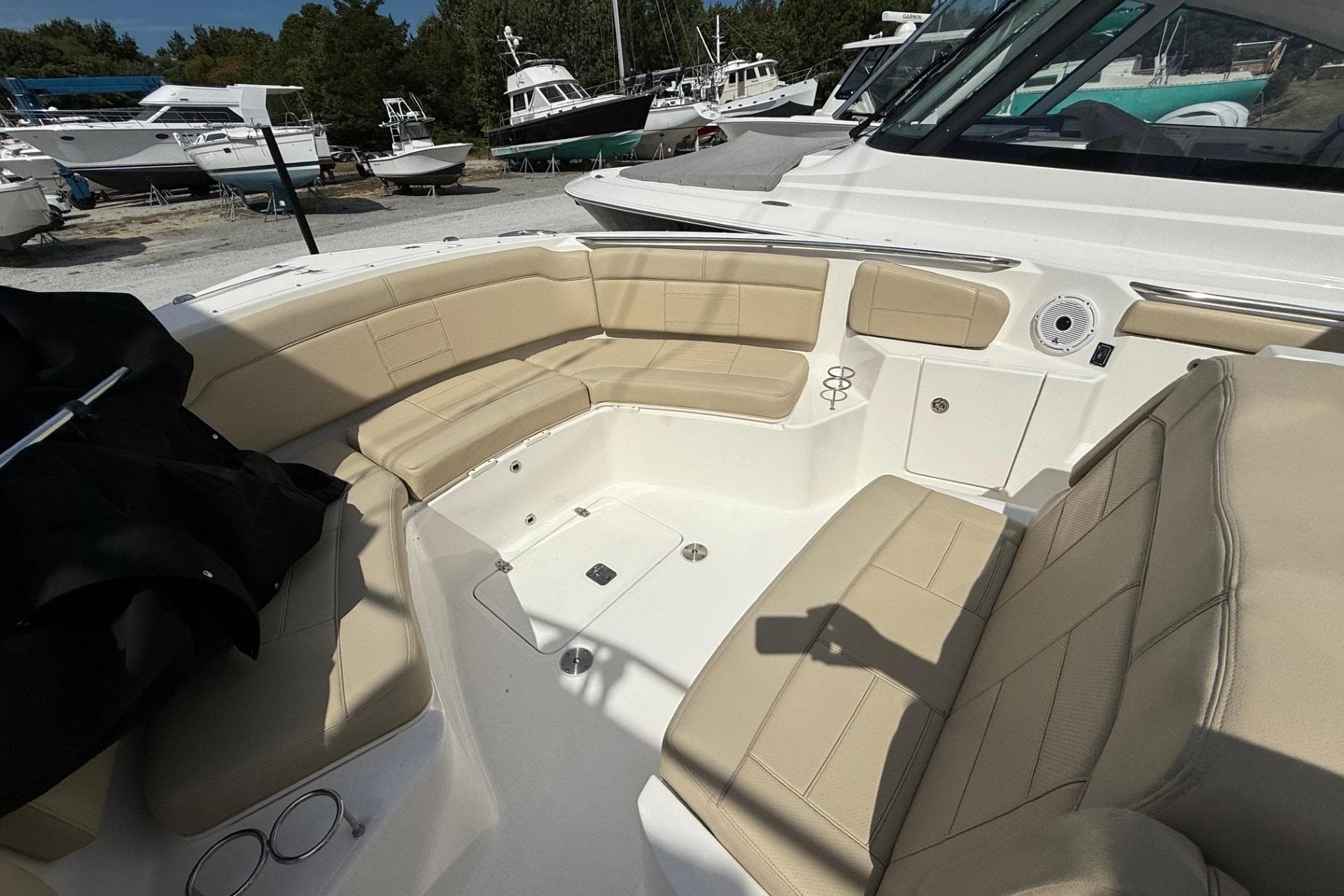 2021 Pursuit S 328 Sport boat interior with beige seating and cup holders.
