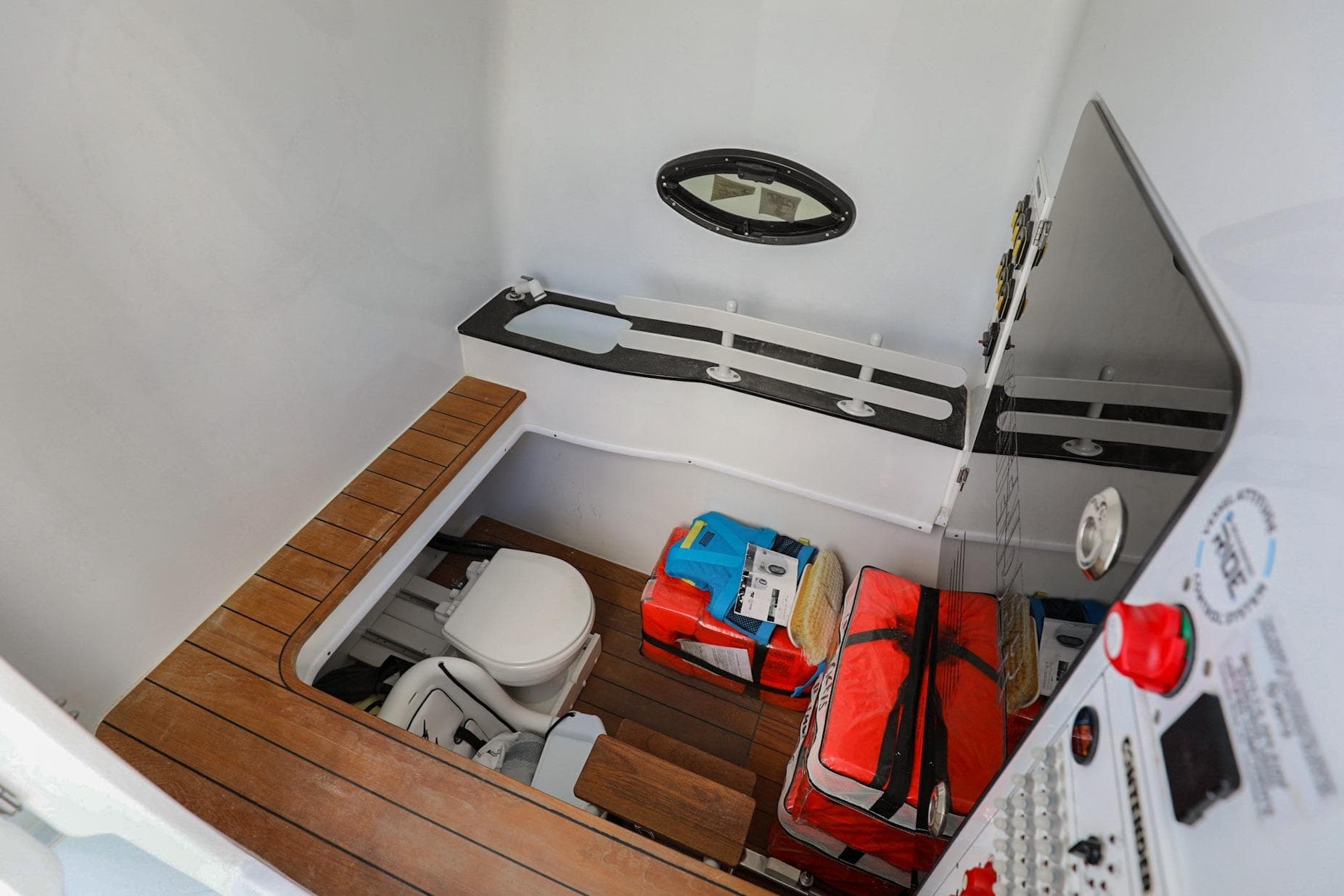 2023 Contender 44 ST boat interior with toilet, storage, and control panel.