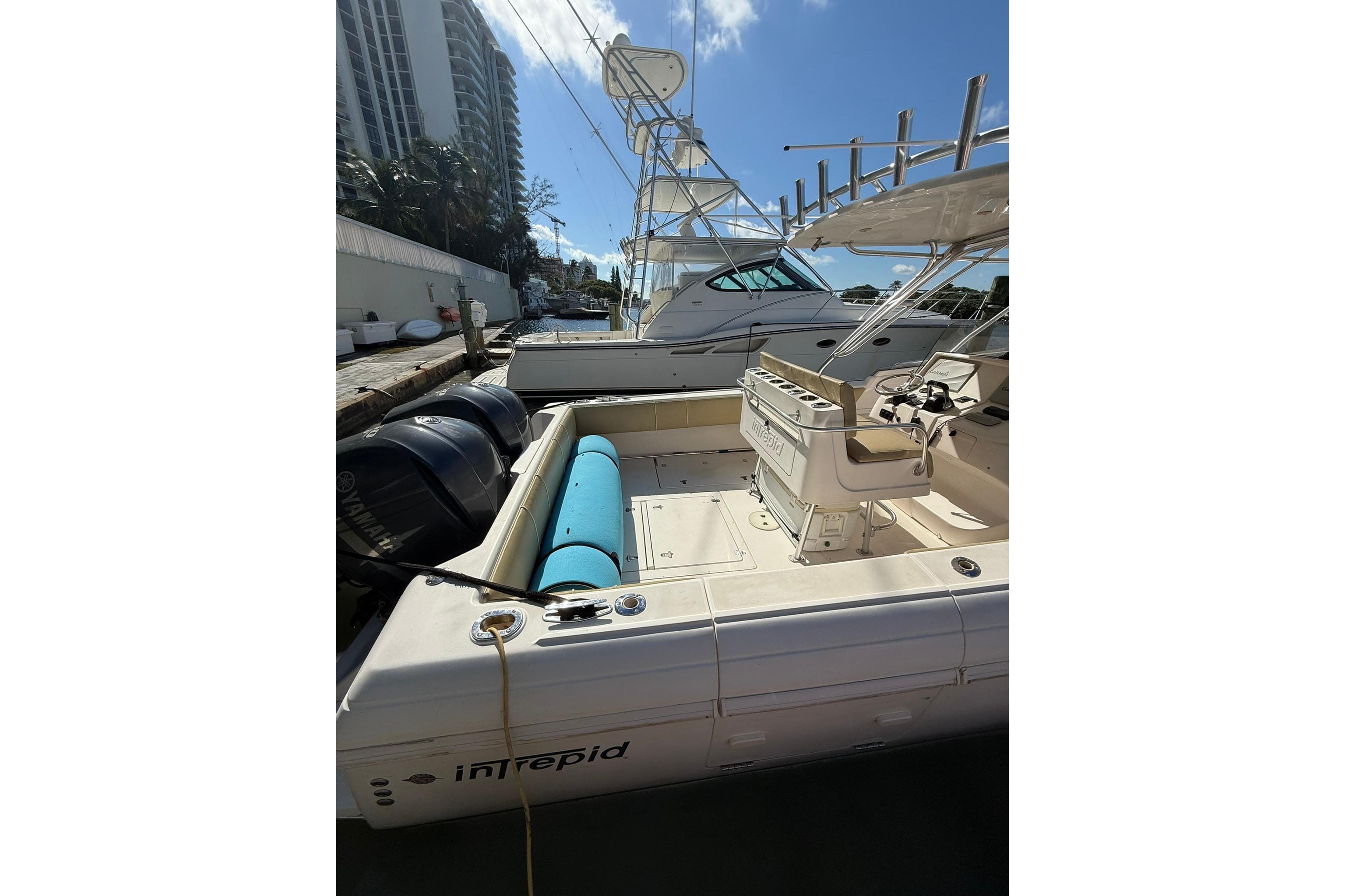 2008 Intrepid 370 Cuddy boat docked, featuring spacious deck and powerful engines.