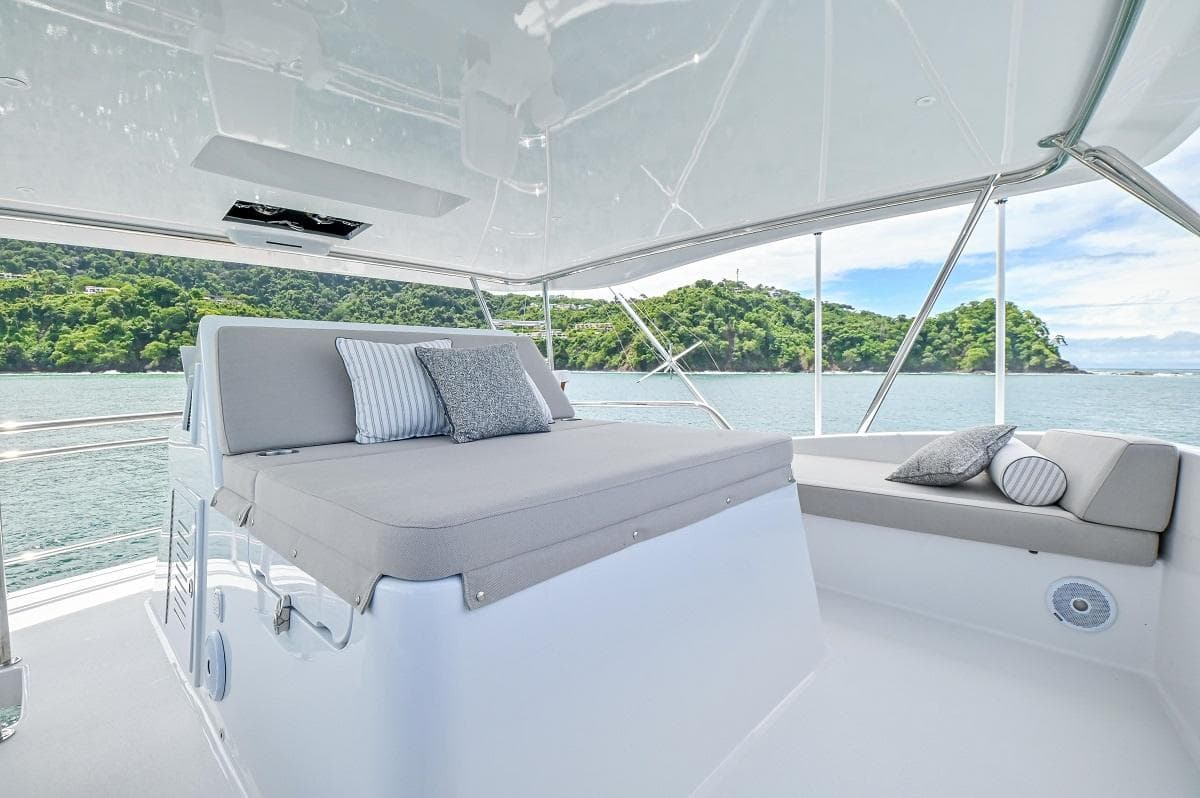 Luxurious 2013 Sea Force IX 94' Sportfisher yacht interior with plush seating and scenic ocean view.
