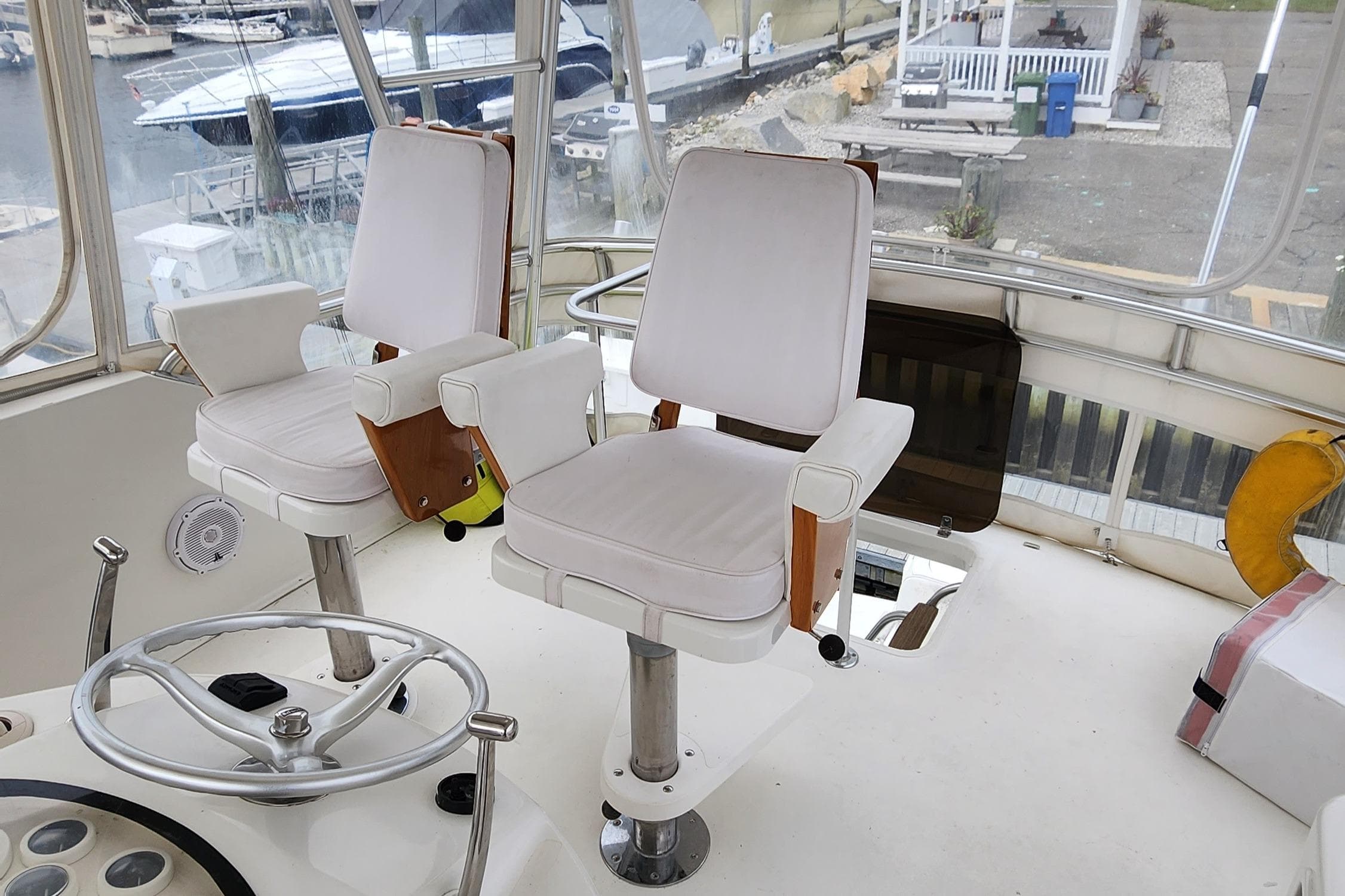2001 Ocean Yachts 56 Super Sport helm with dual captain chairs and steering wheel.