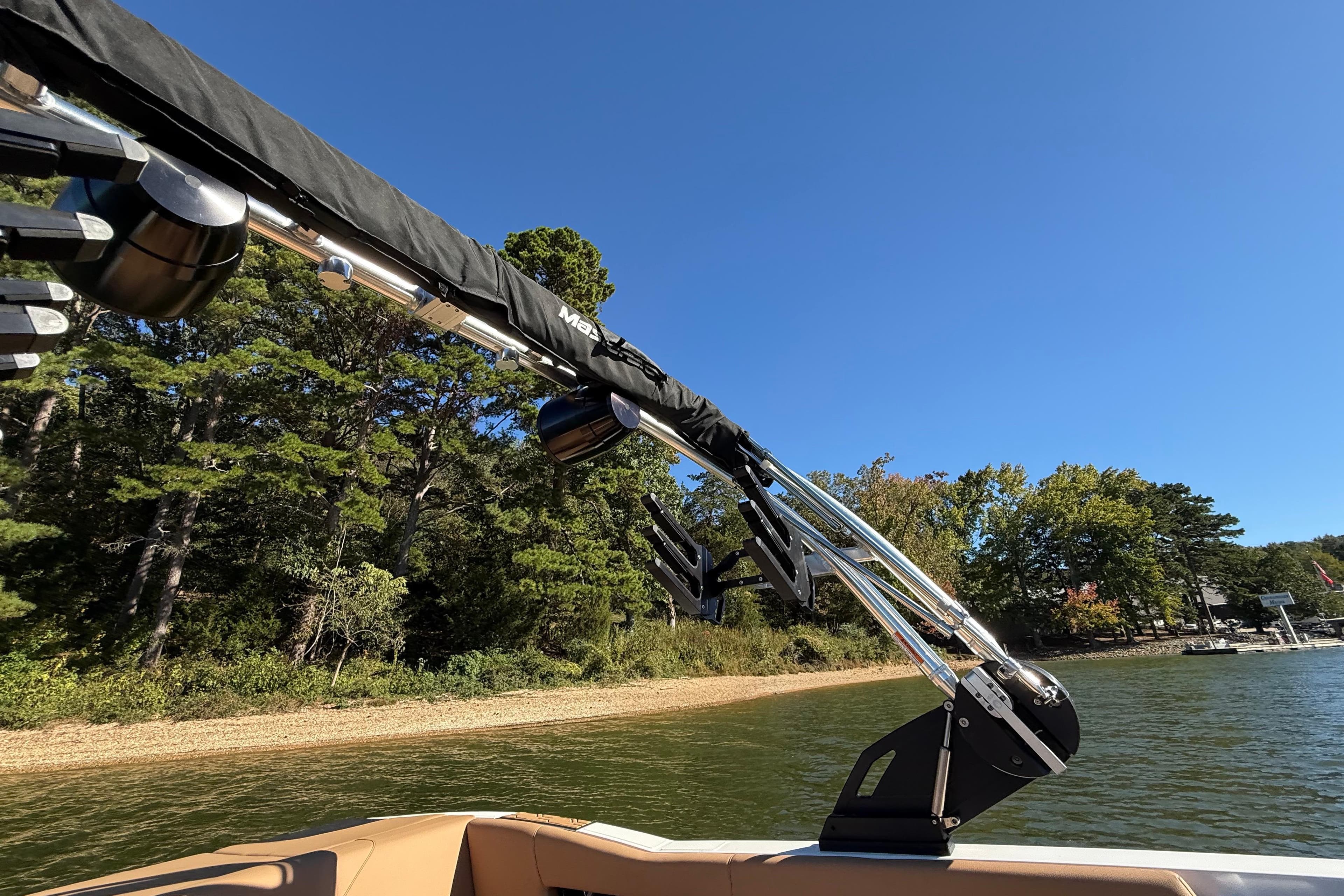 2022 MasterCraft NXT24 boat with wakeboard tower on a sunny lake.