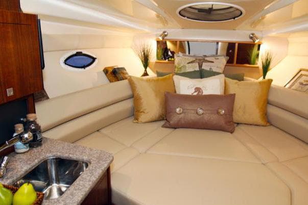 Luxurious interior of 2015 Monterey 295 Sport Yacht with plush seating and elegant decor.
