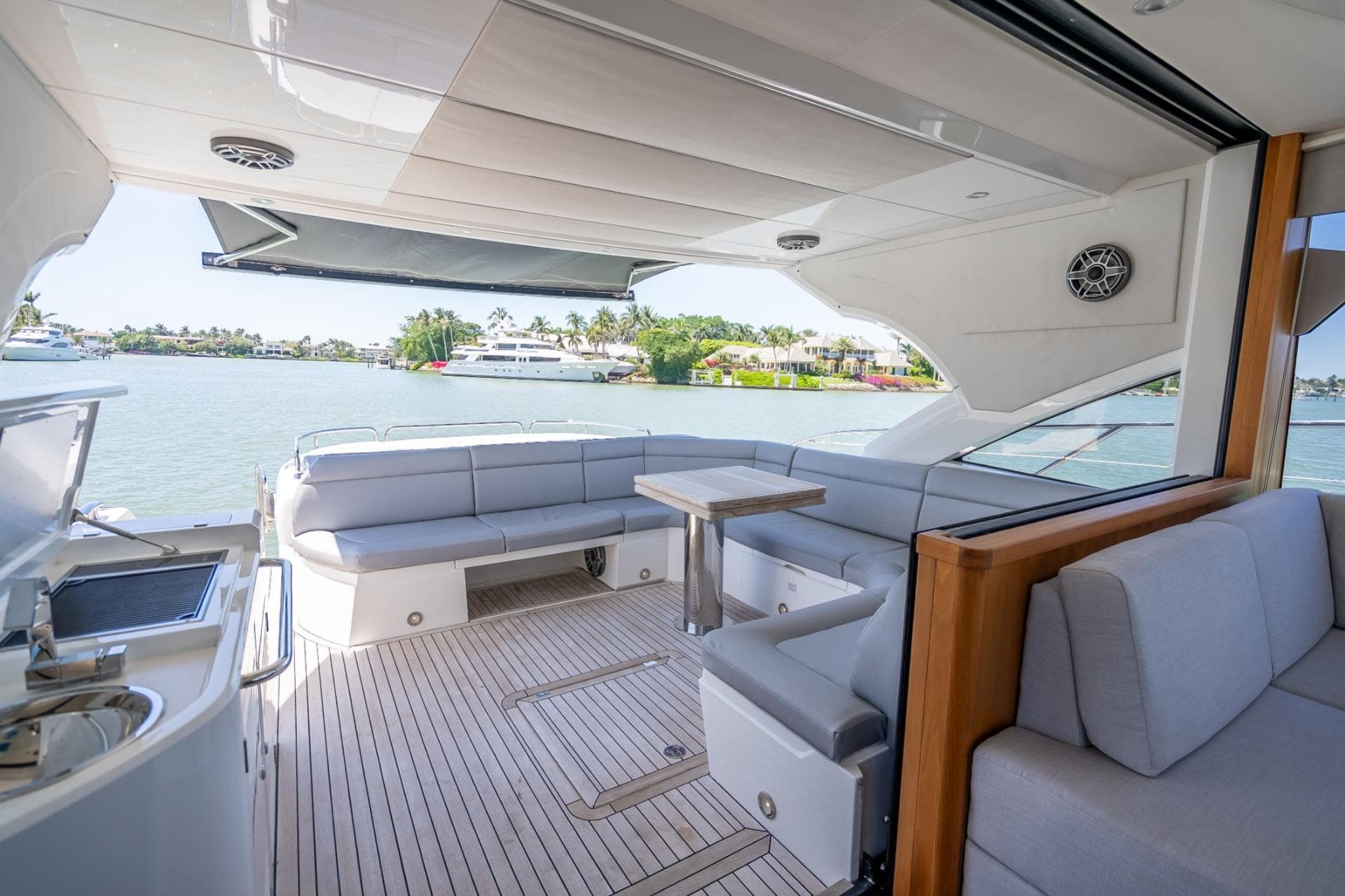 Luxurious 2018 Sunseeker Predator 57 yacht interior with spacious seating and scenic water view.