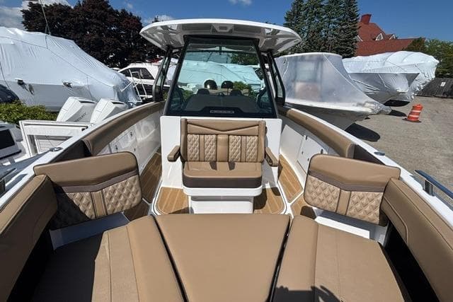 2026 Monterey Elite 30 OB boat interior with tan seating and modern design.