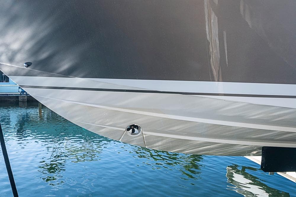 2023 Tiara Sport 34 LS boat hull reflecting on calm water.
