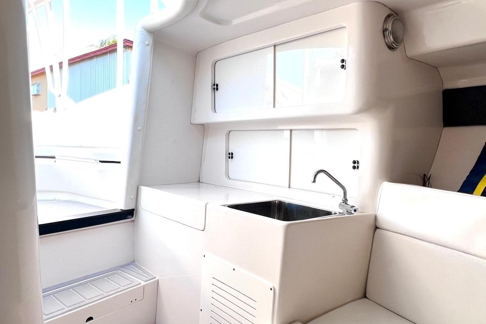 Interior of a 2002 Intrepid 366 boat featuring a compact kitchenette with sink.