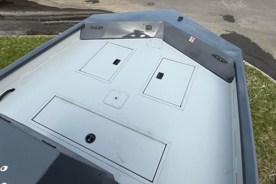 2026 Crestliner 1870 Retriever FCC boat deck with storage compartments.