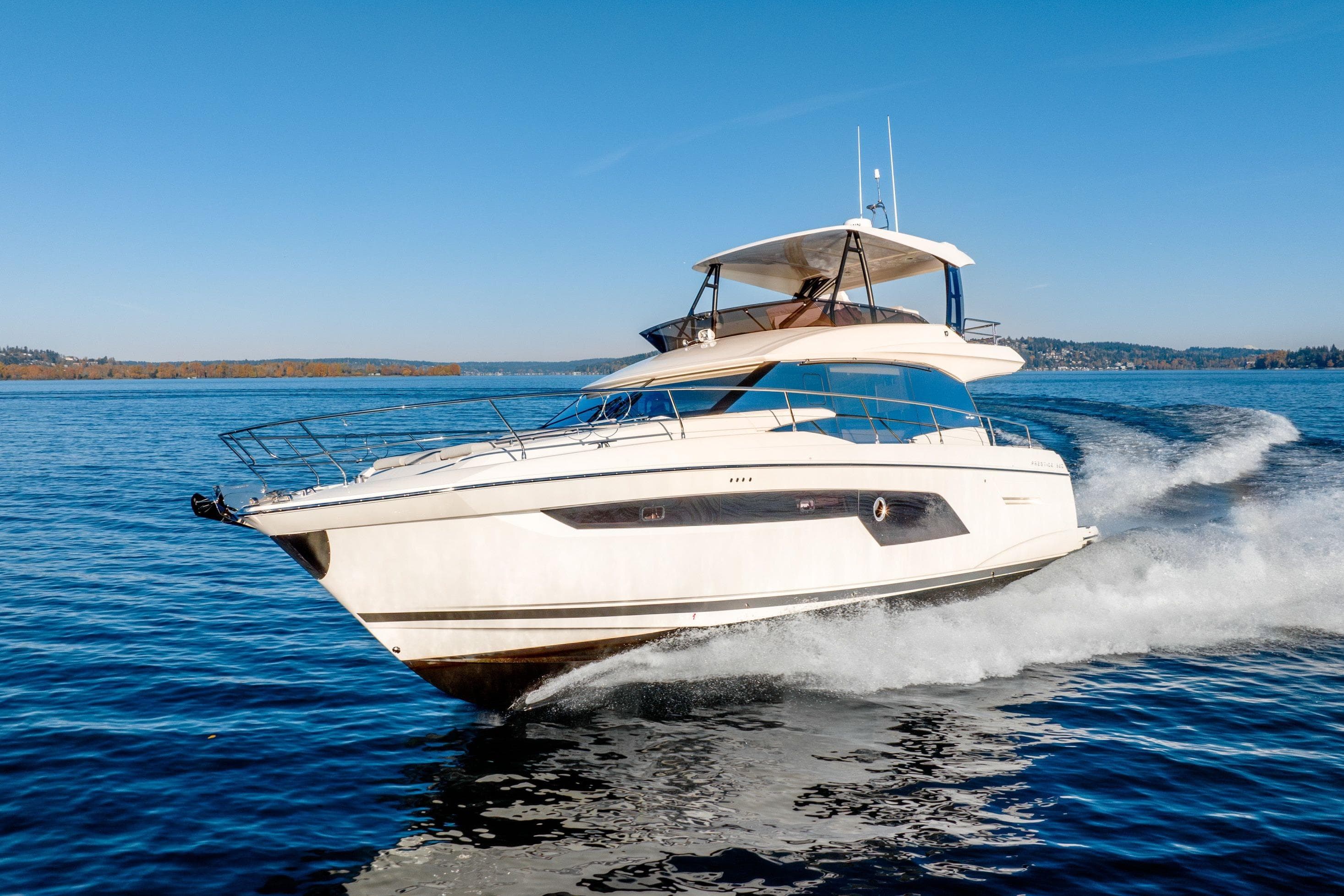 Luxury 2026 Prestige 520 yacht cruising on a clear blue lake.