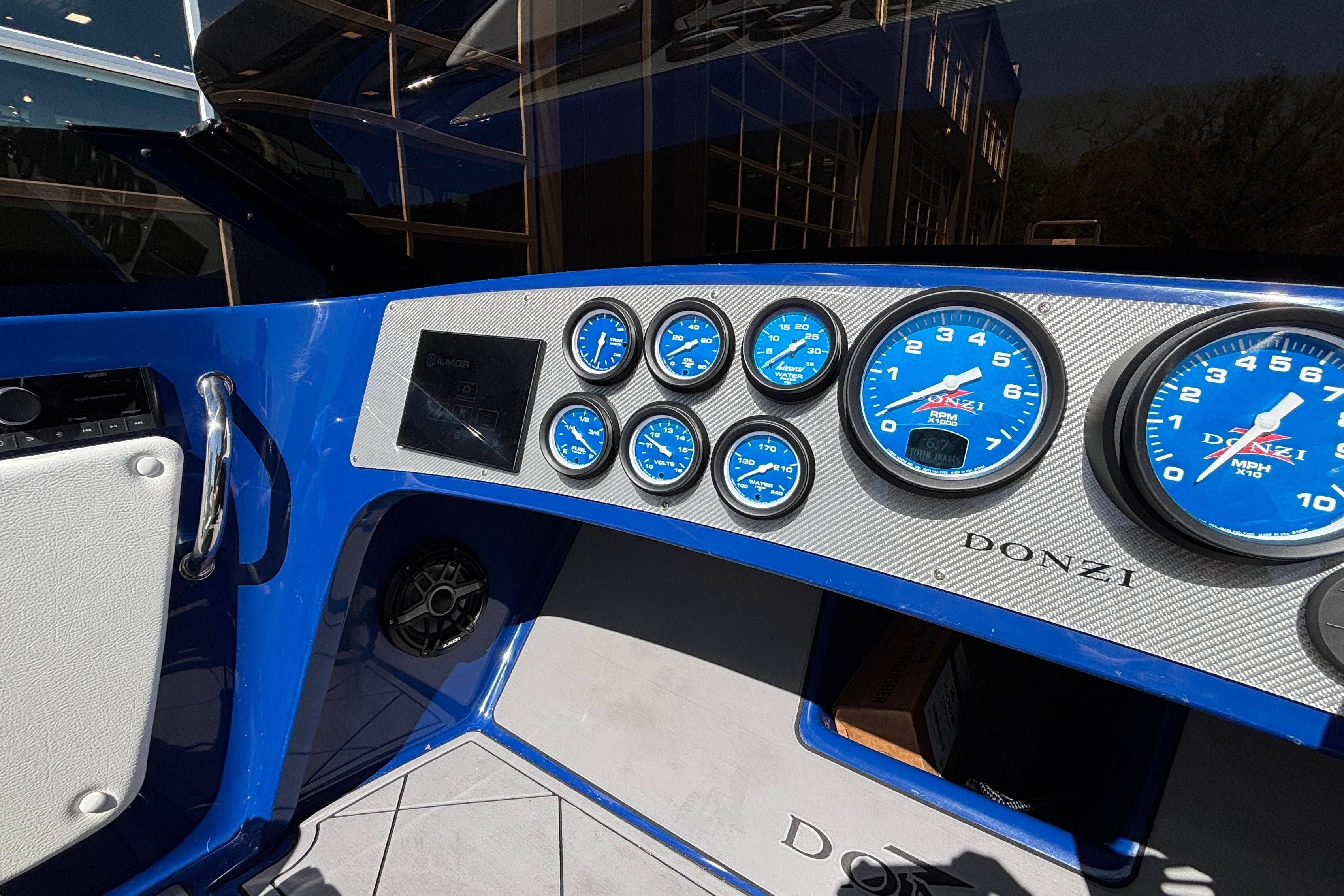 Dashboard of 2026 Donzi 22 Classic boat with blue gauges and modern controls.